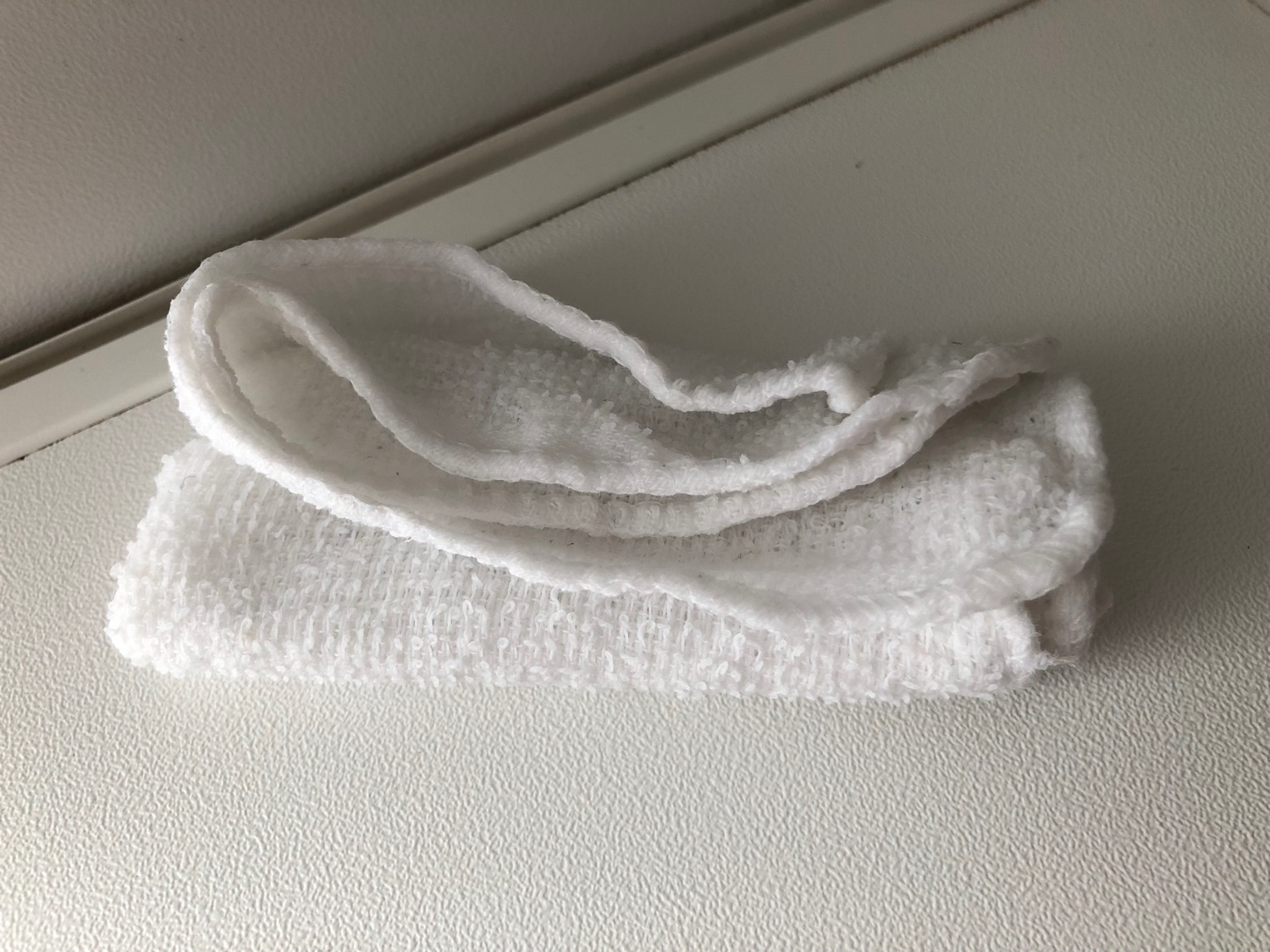 a white towel on a white surface