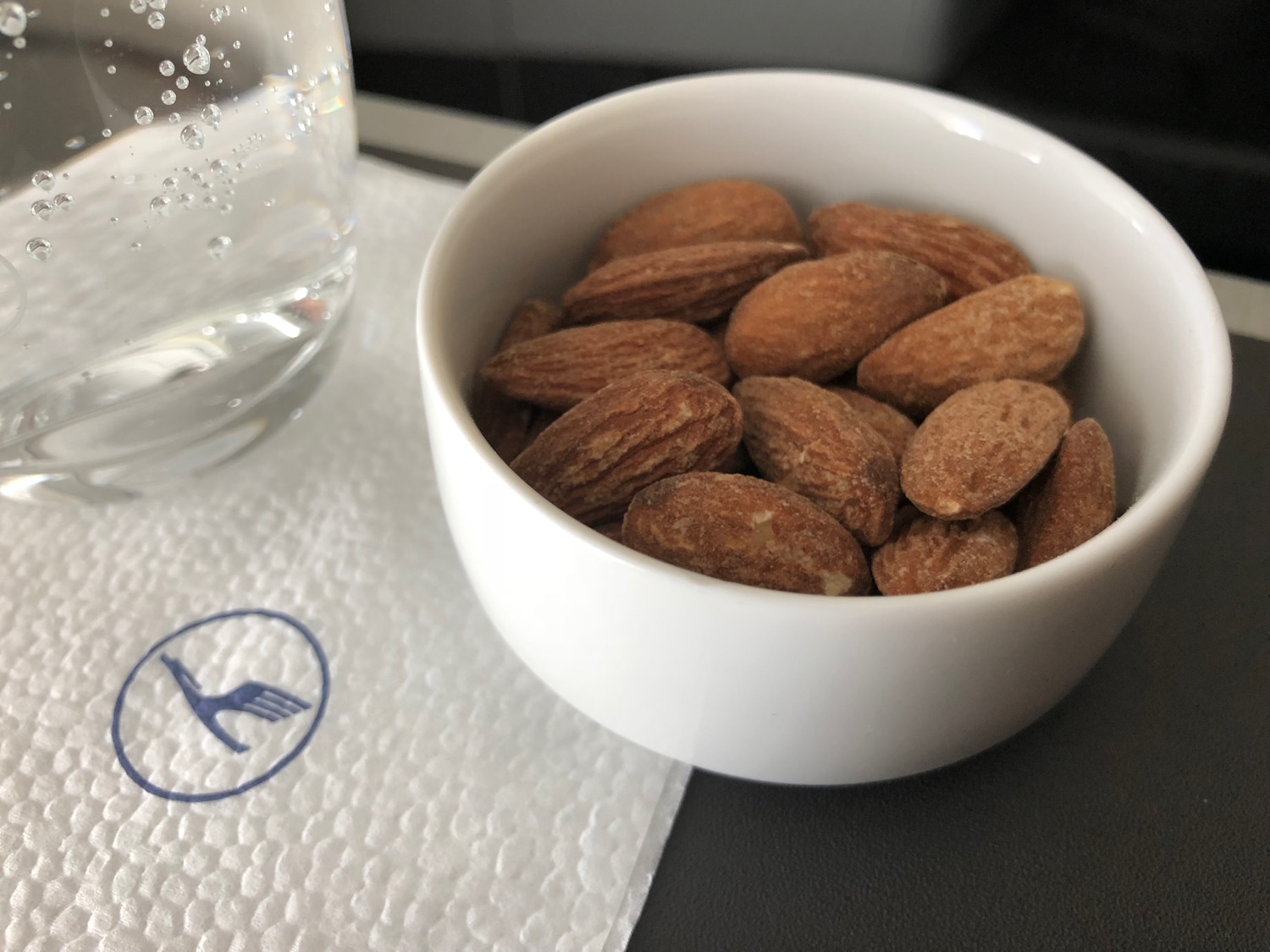 a bowl of almonds on a napkin