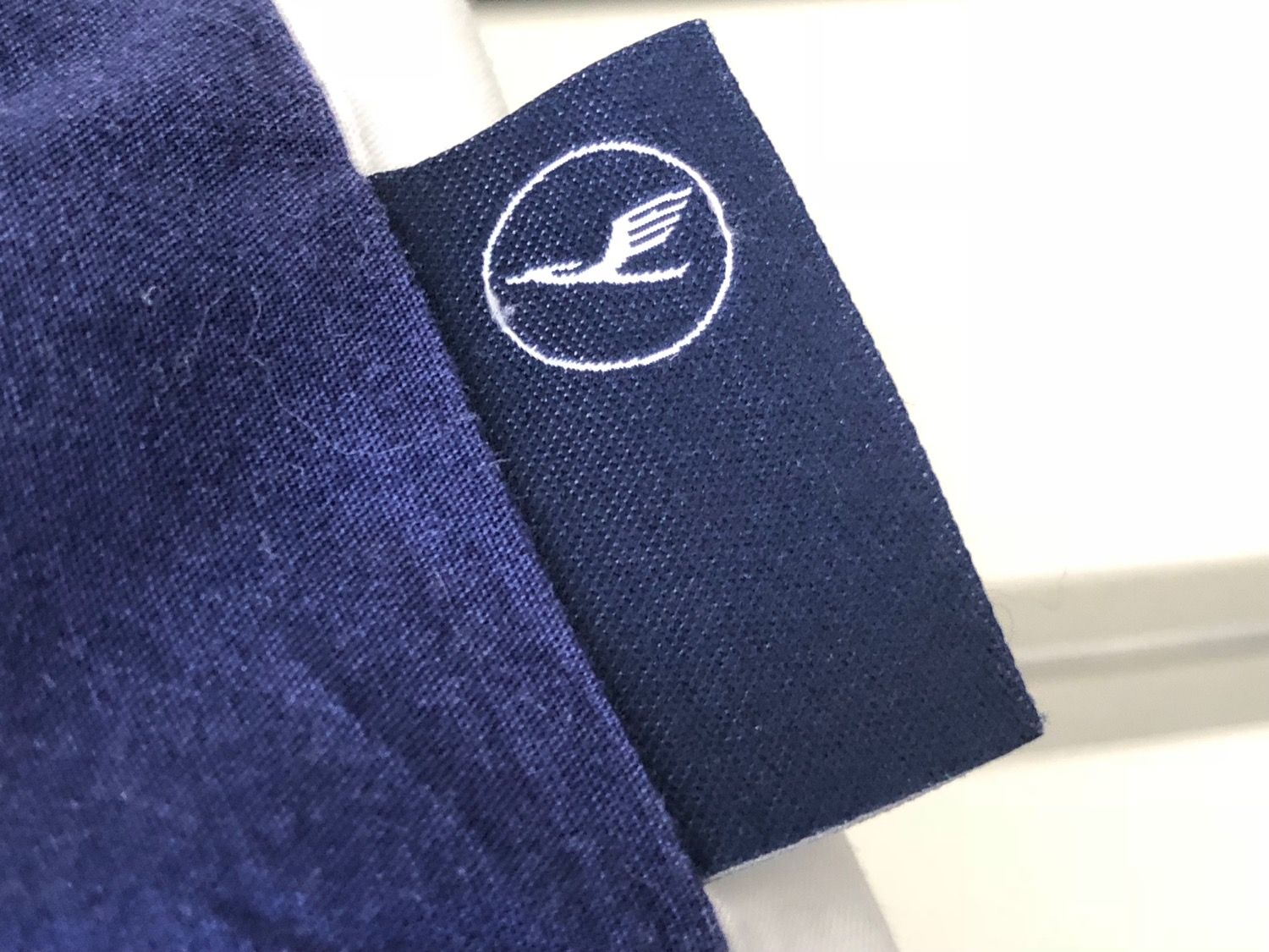 a blue fabric with a white logo