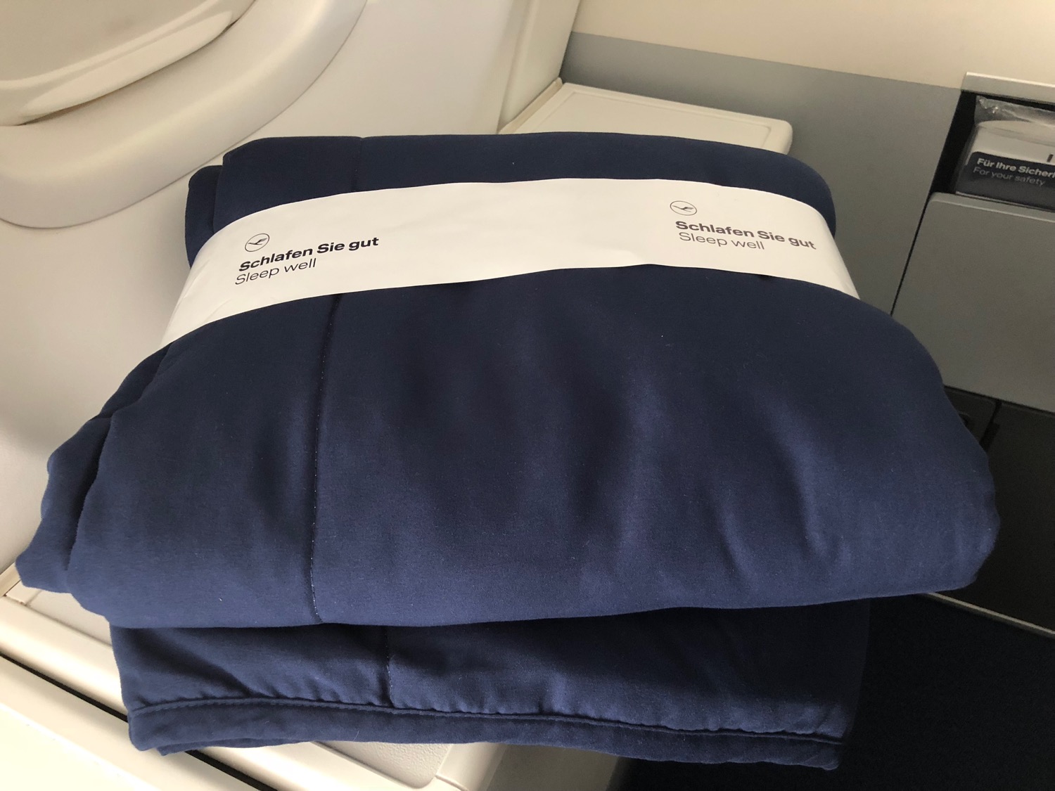a folded blanket on a plane