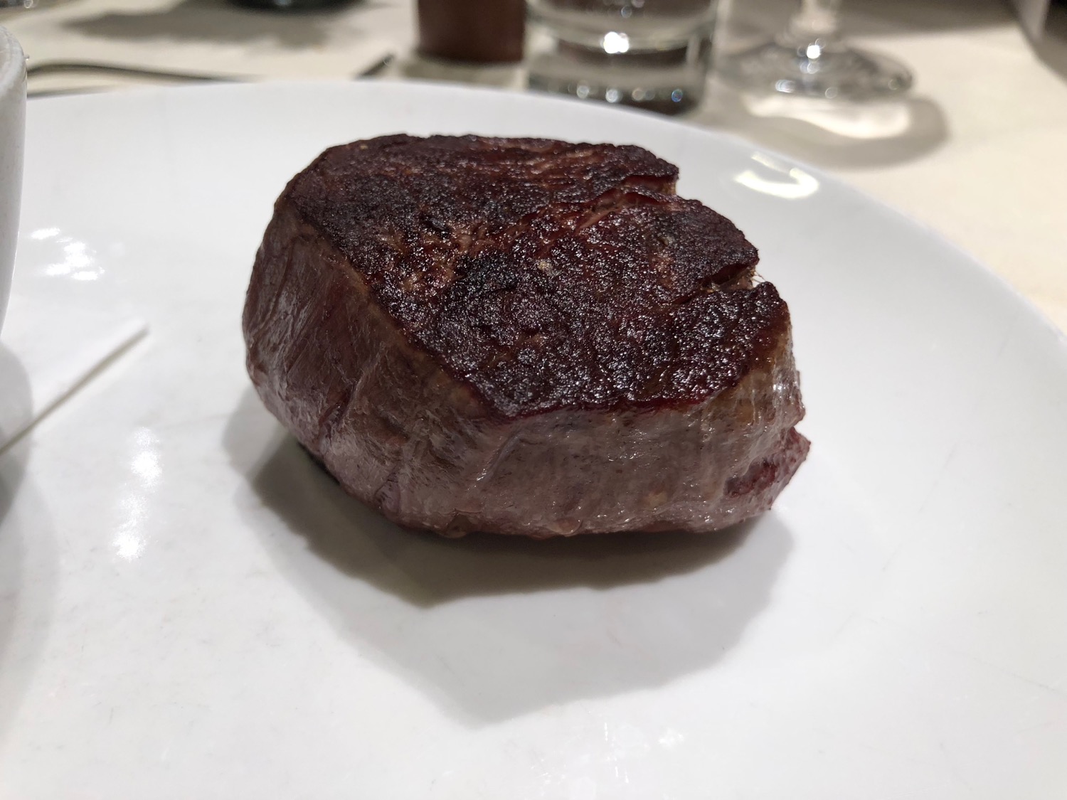 a piece of meat on a white plate