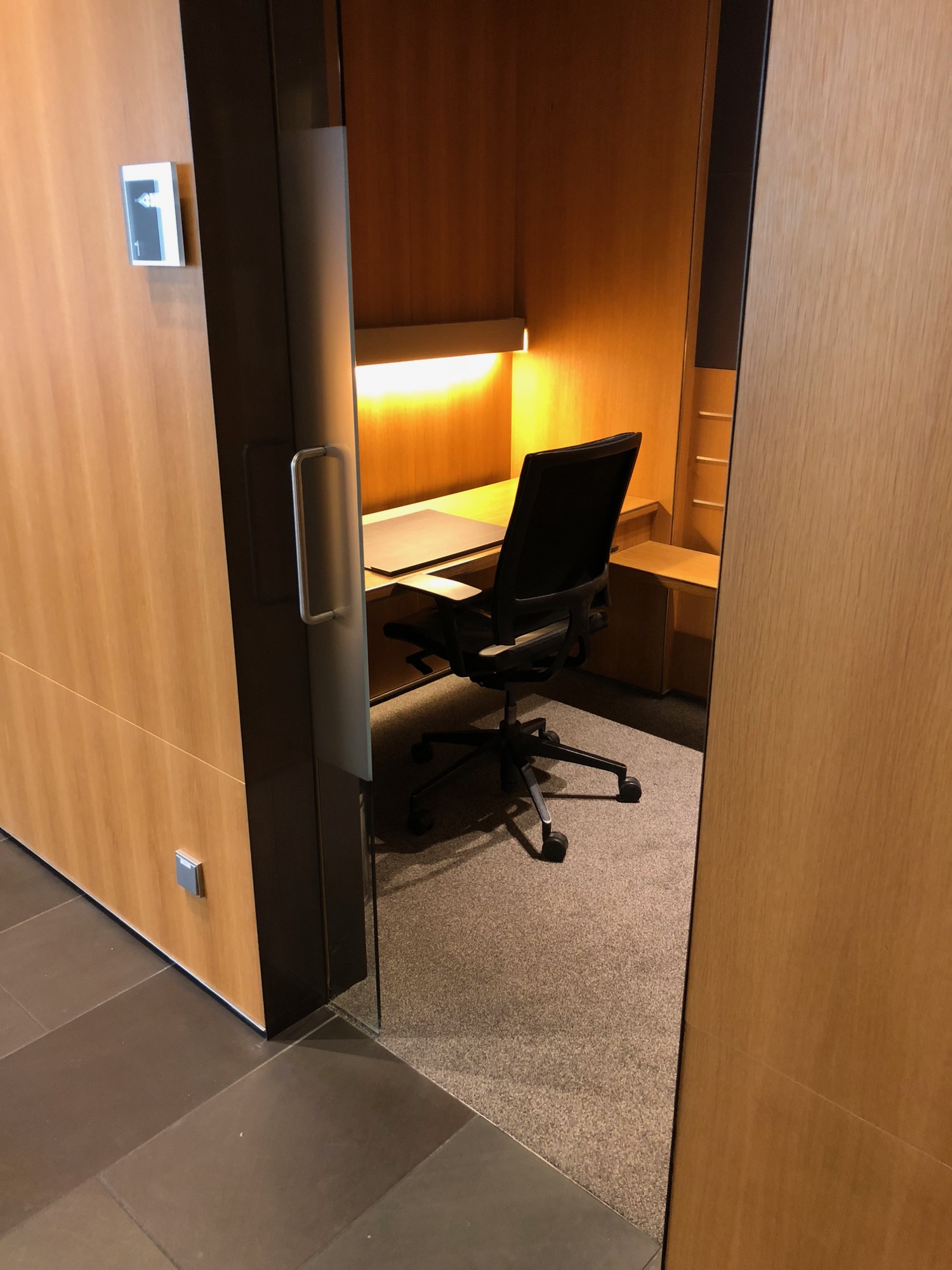 a desk in a room with a door open