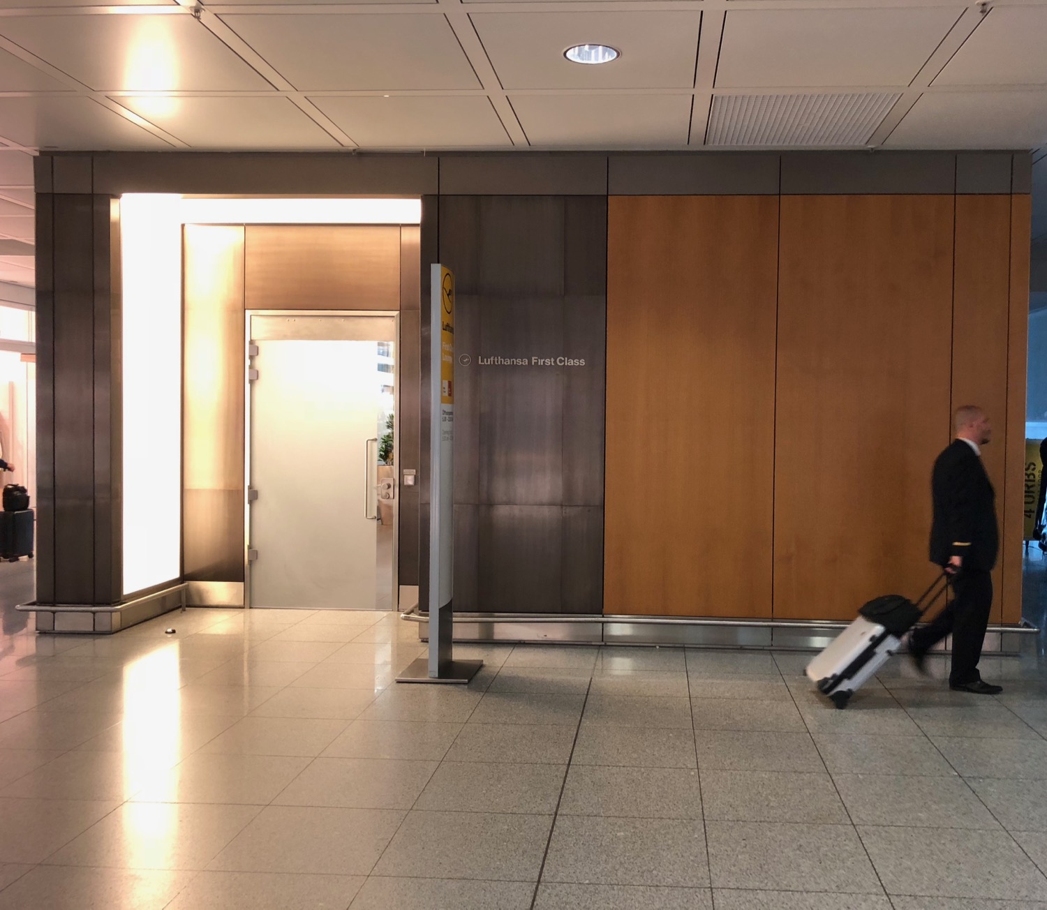 a man with luggage in a lobby