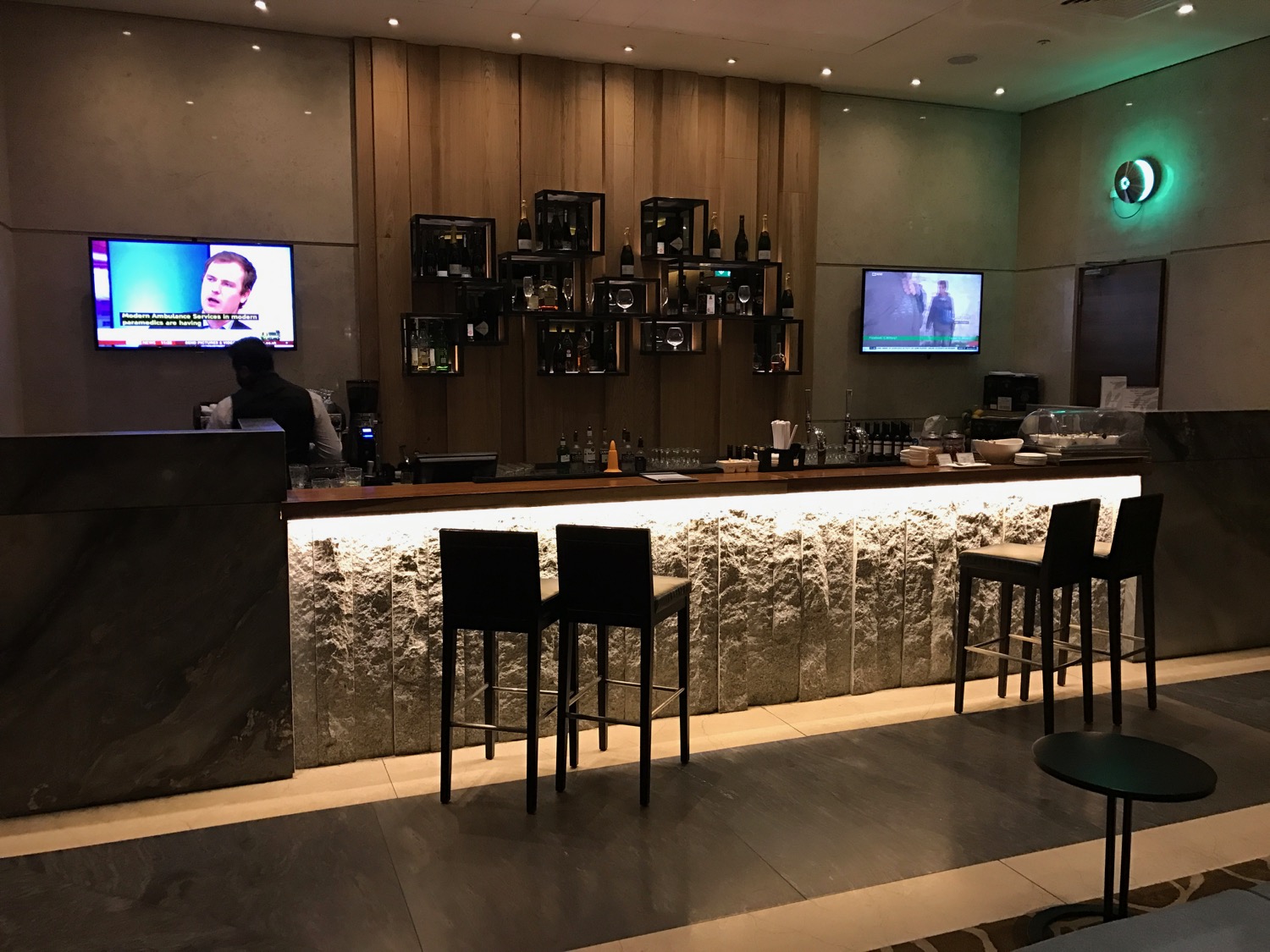 a bar with a television and a tv on the wall