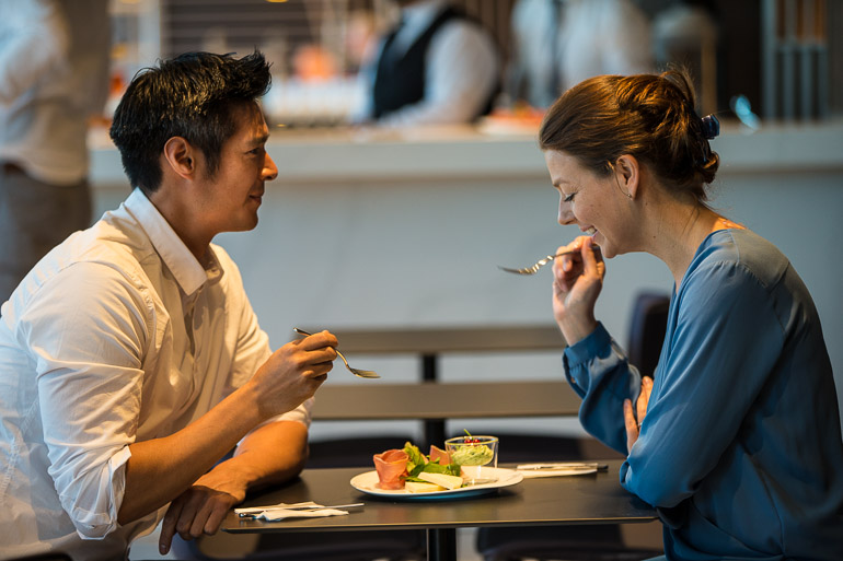 a man and woman eating at a table