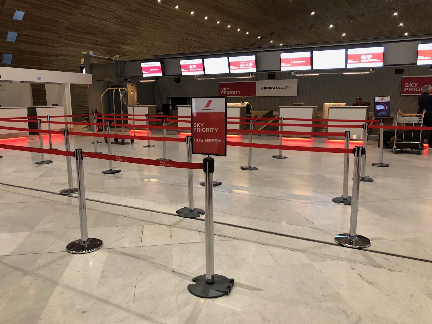 a red and silver barriers in a airport