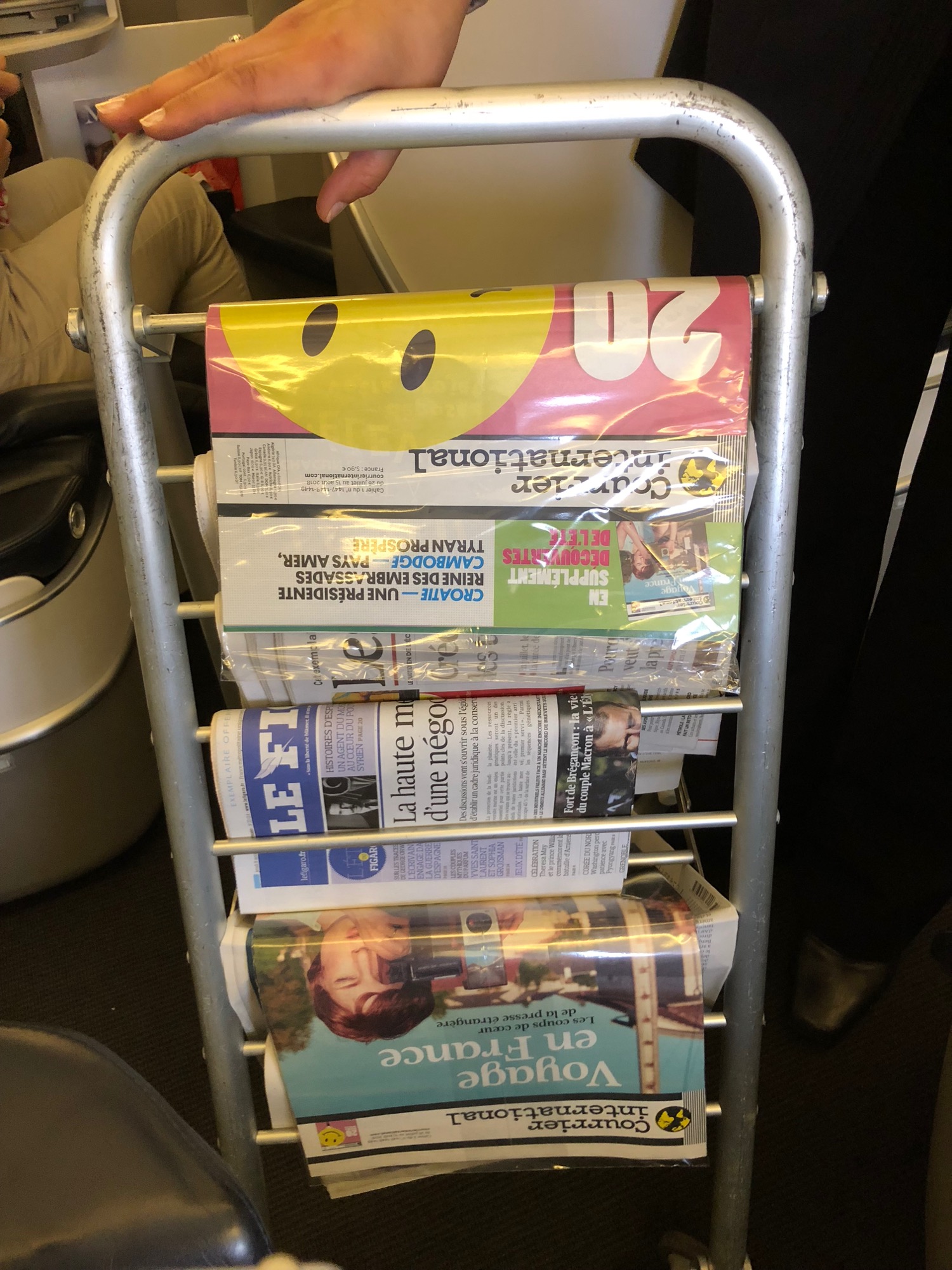 a metal rack with several newspapers