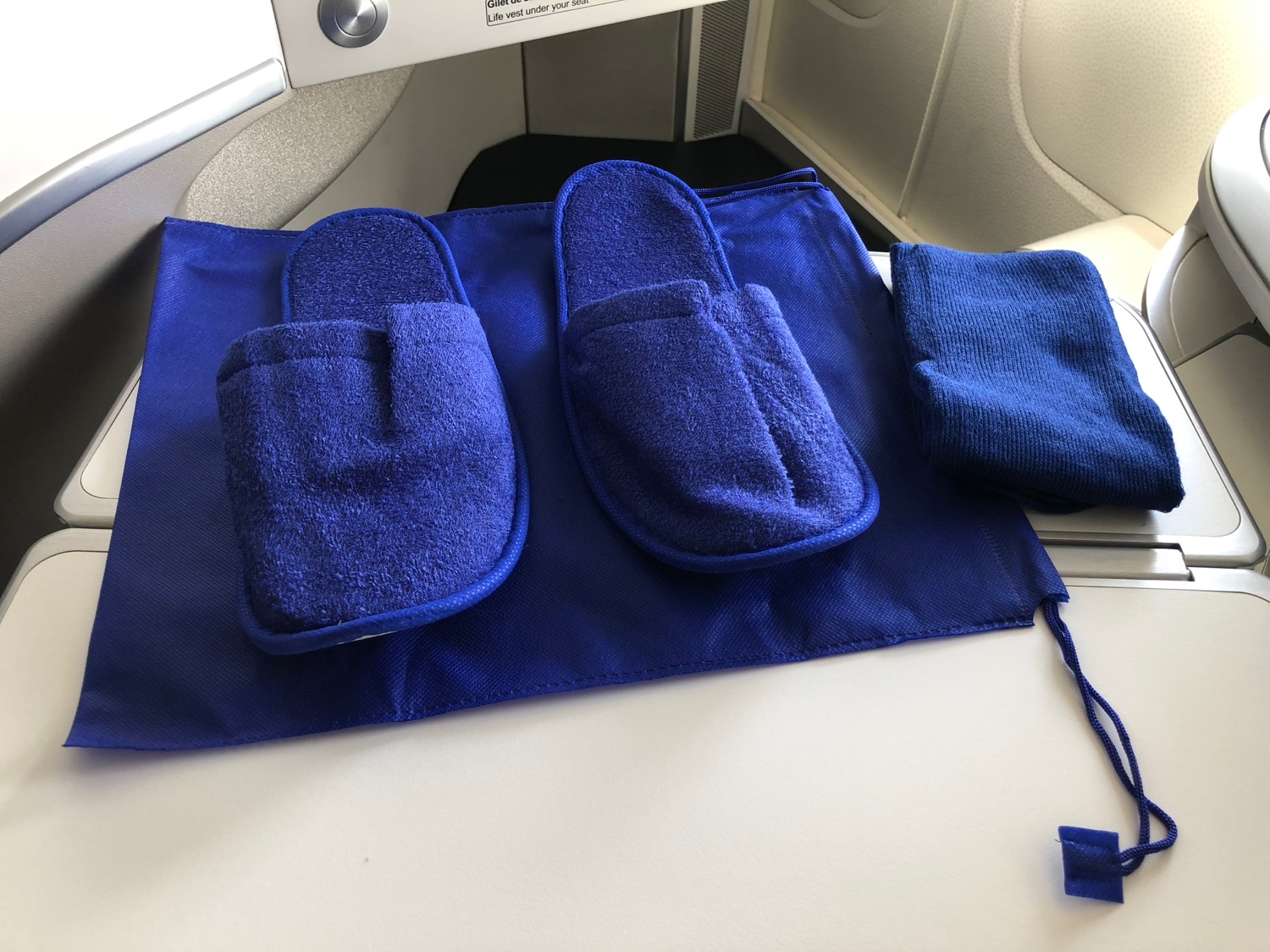a blue slippers and a towel on a table