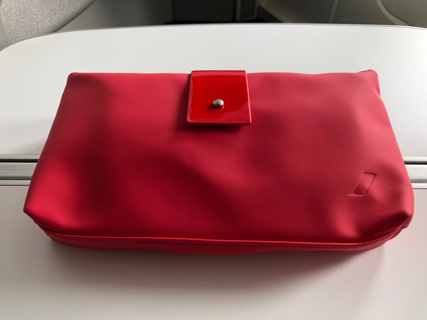 a red bag on a white surface