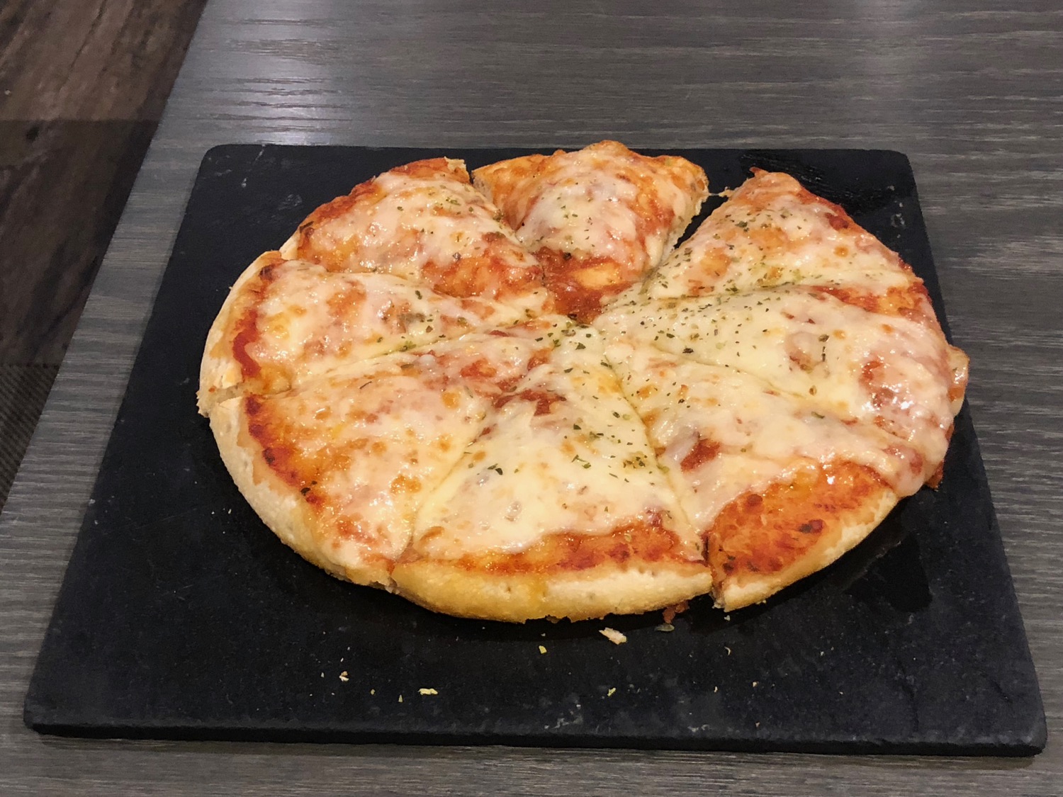 a pizza on a black plate
