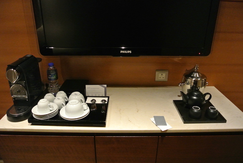 Nespresso and cabinet with safe, mini fridge and storage. TV not pictured above.