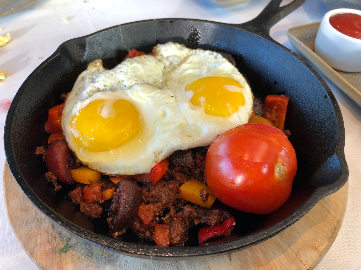 a skillet with eggs and tomatoes