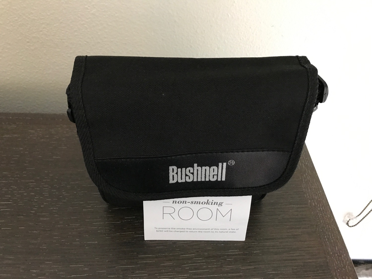 a black bag with a white label on a table