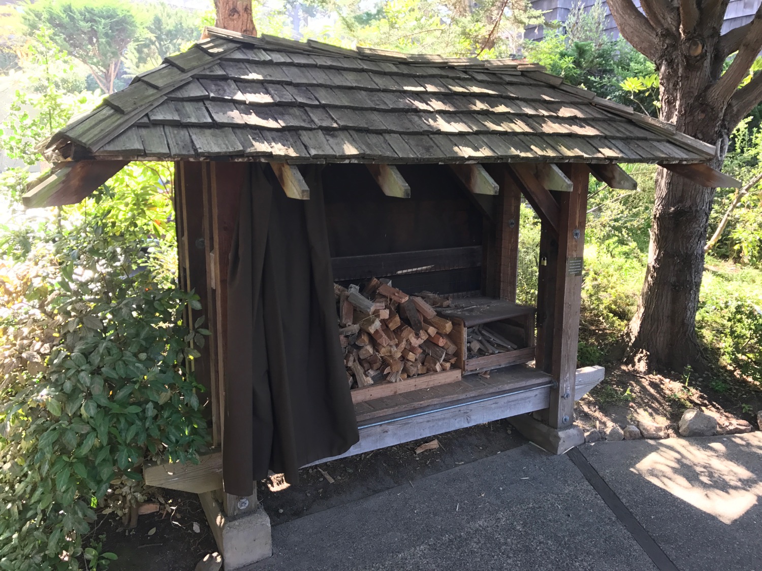 a wood shed with a pile of wood