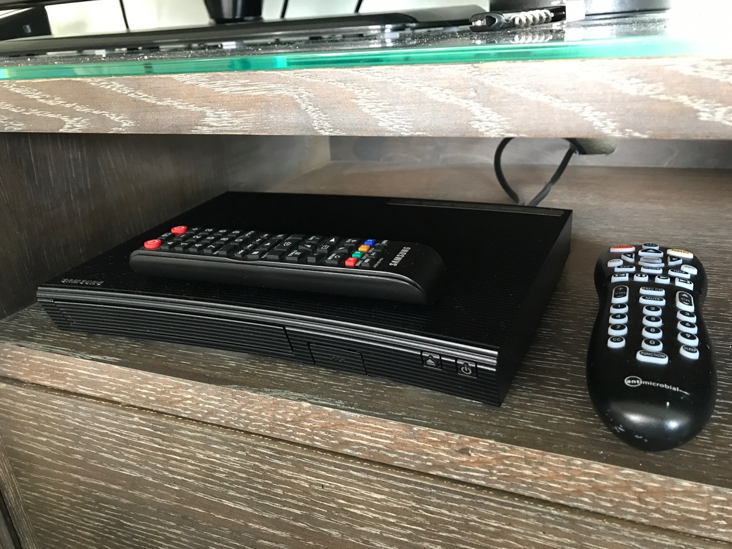 a black box with a remote control on top of it