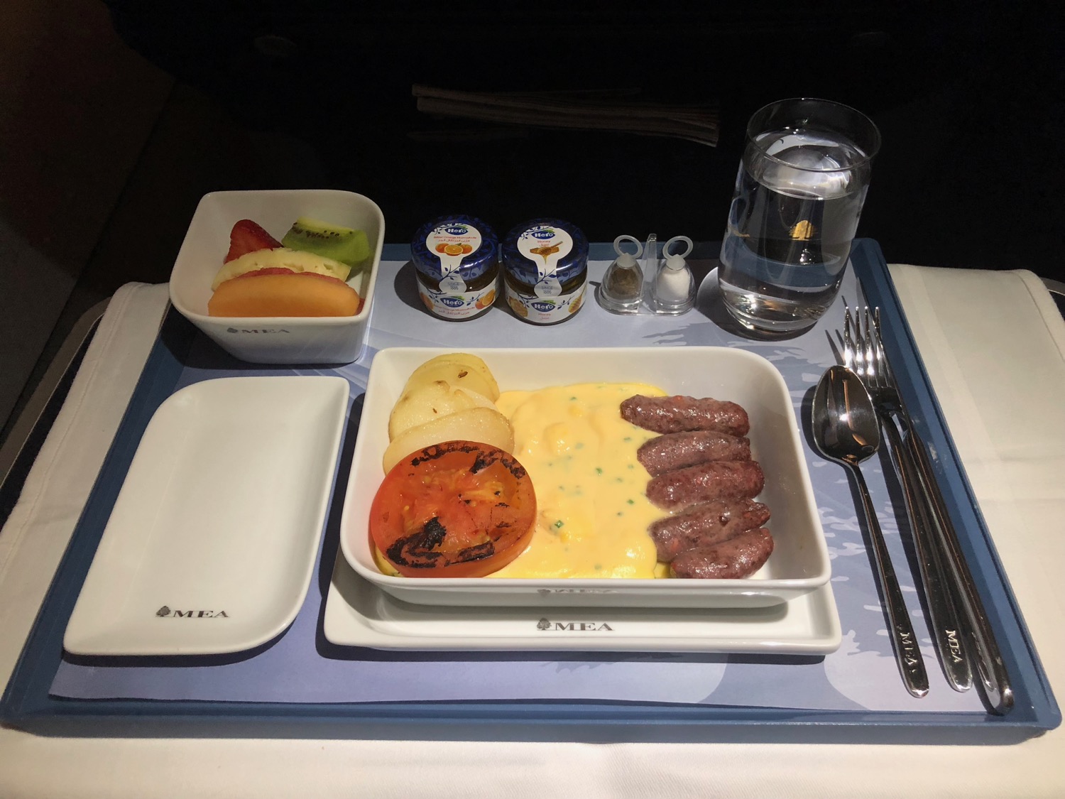 a tray with food and a glass of water