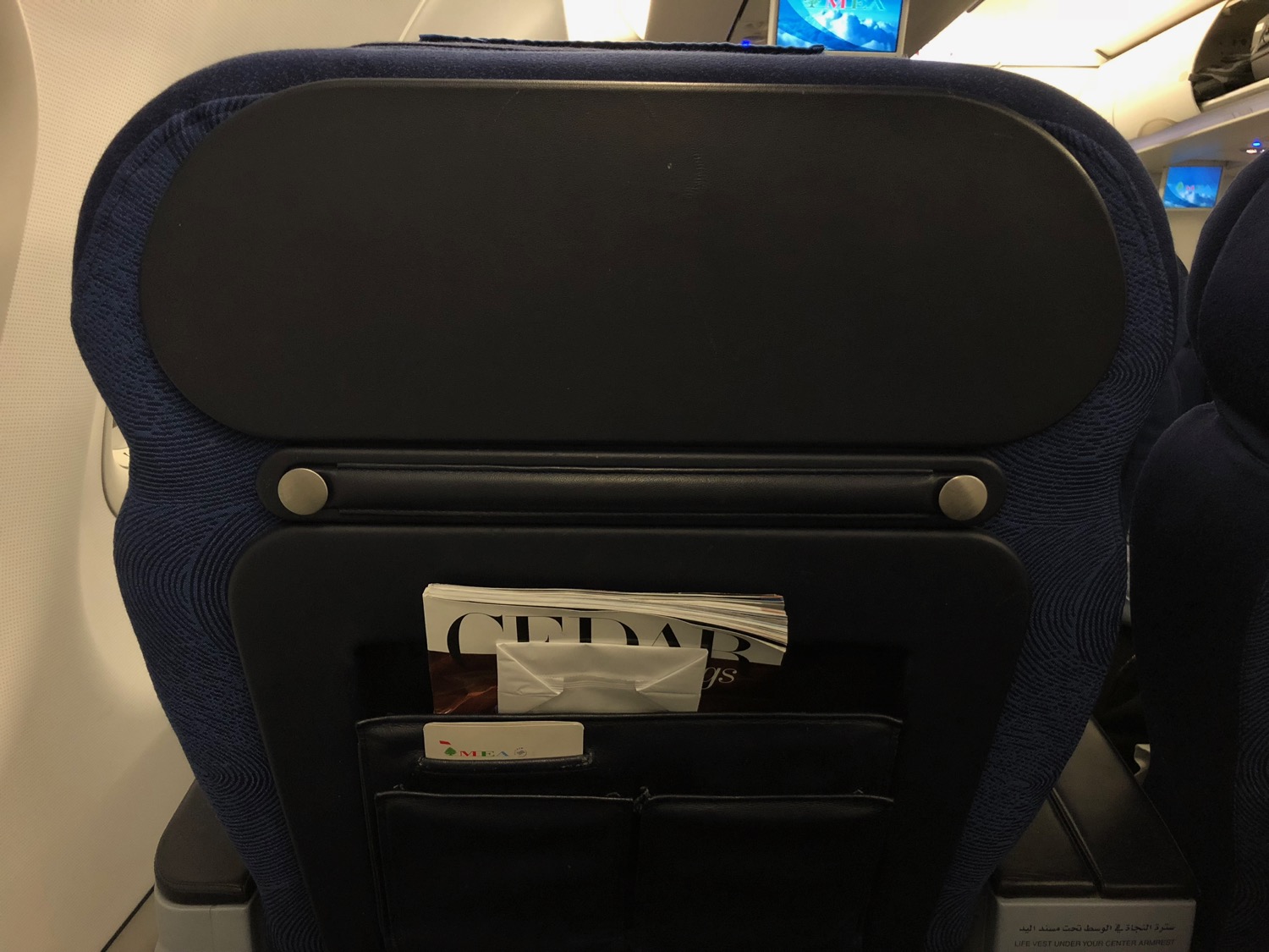 a seat with a magazine in the pocket