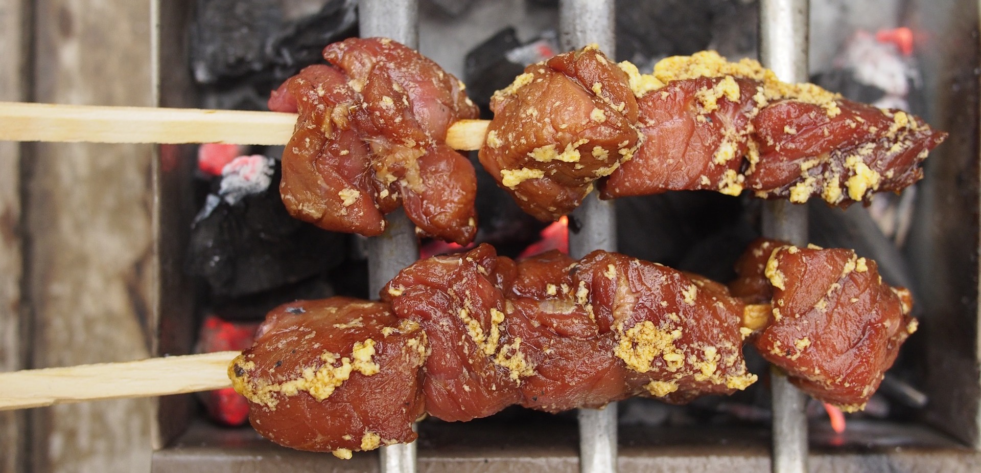 meat on skewers on a grill