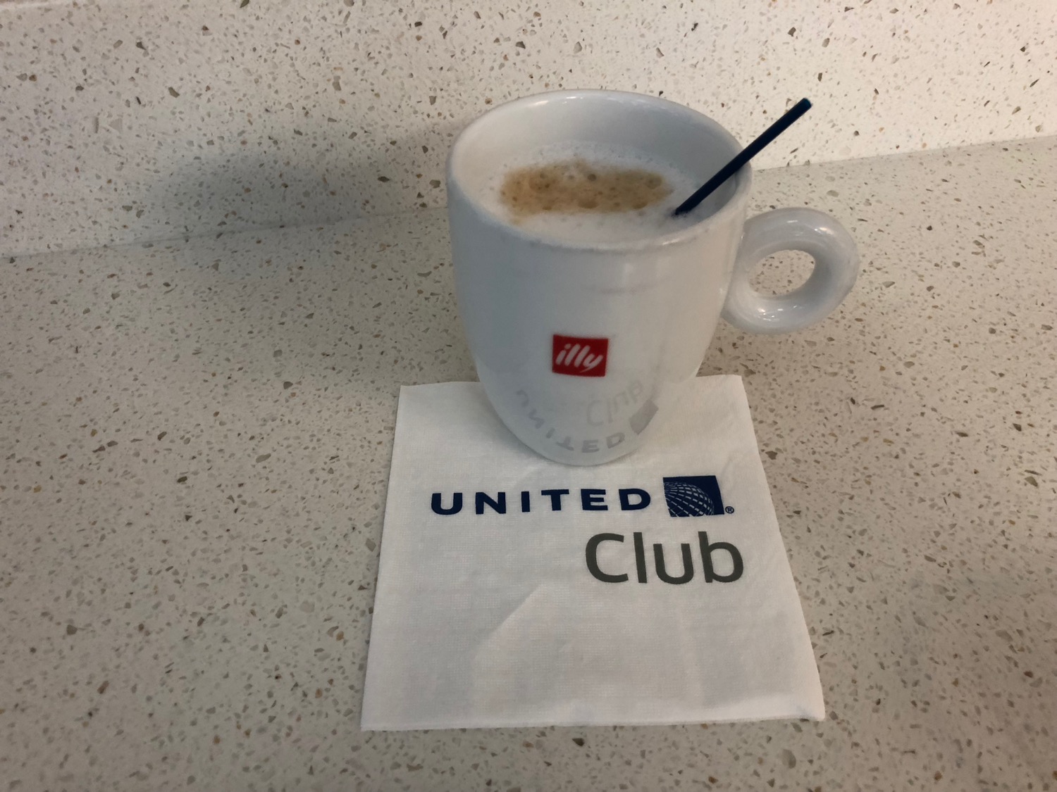 a white mug with a straw on a napkin