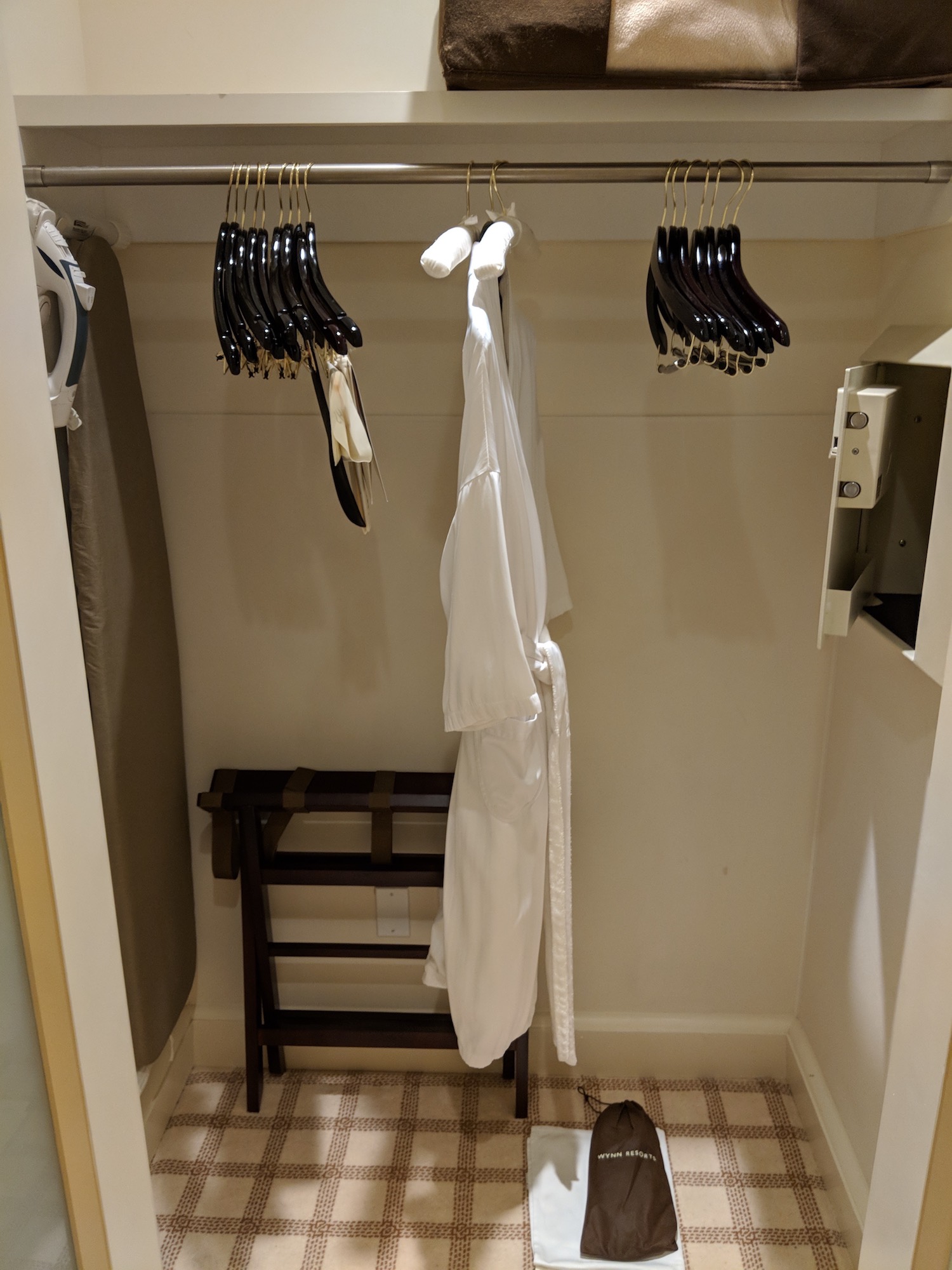 a closet with white clothes on a bar