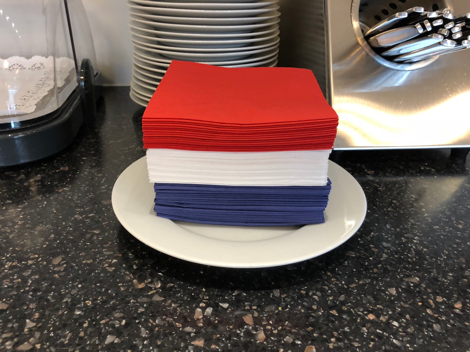 a stack of red white and blue napkins on a plate