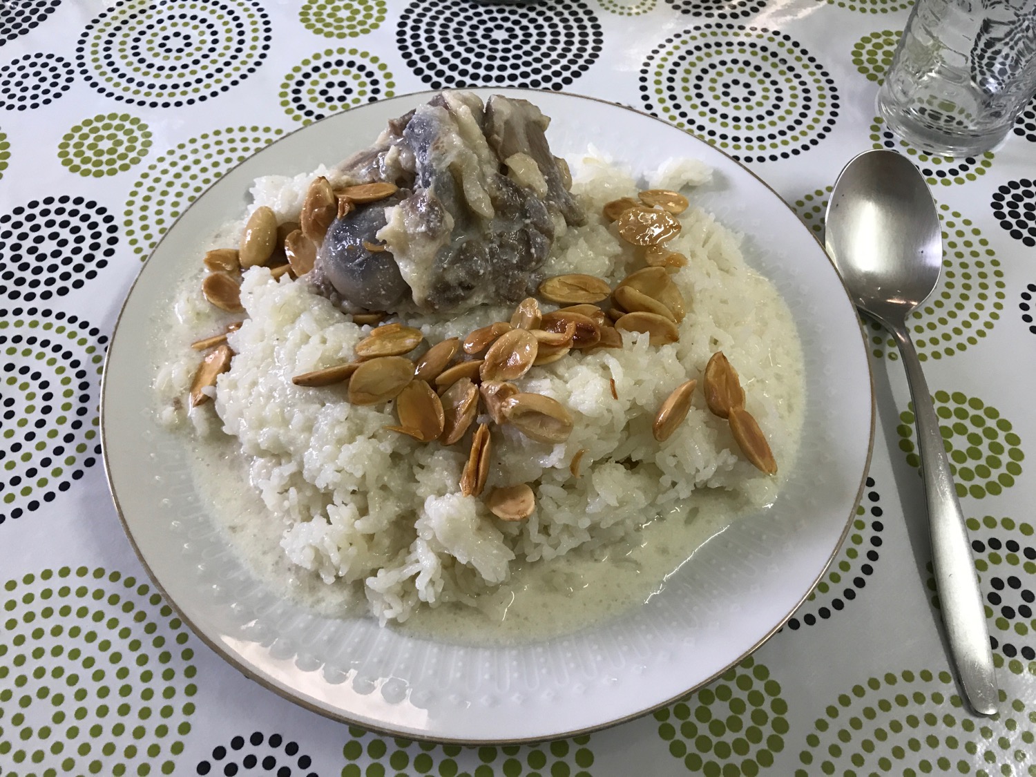 a plate of rice and meat with almonds