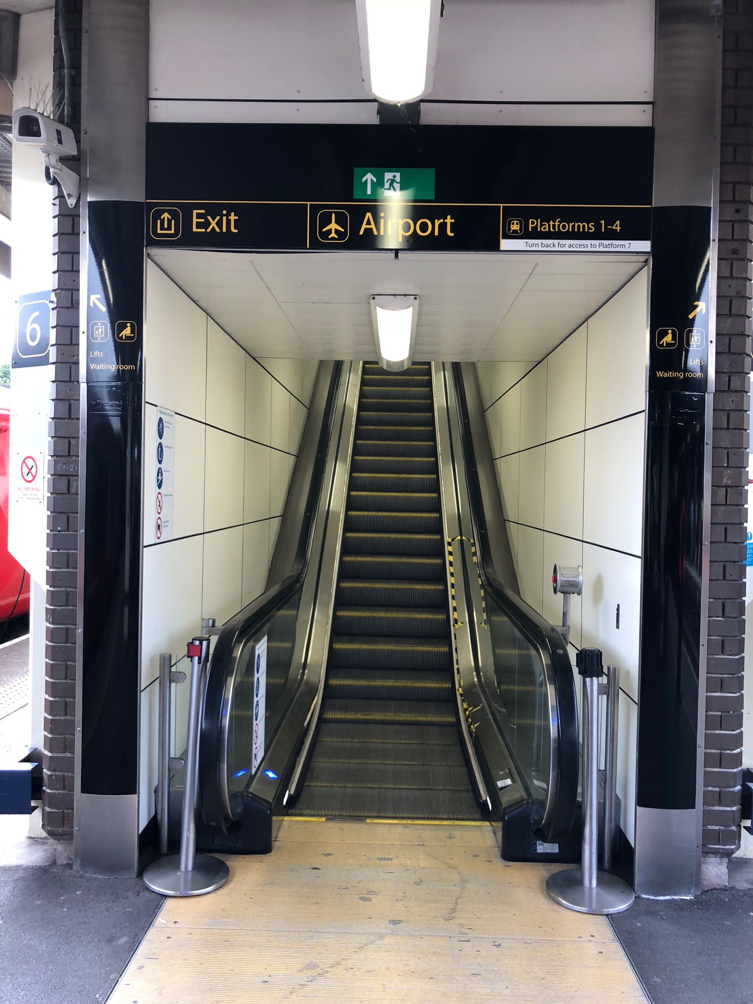 an escalator with a sign