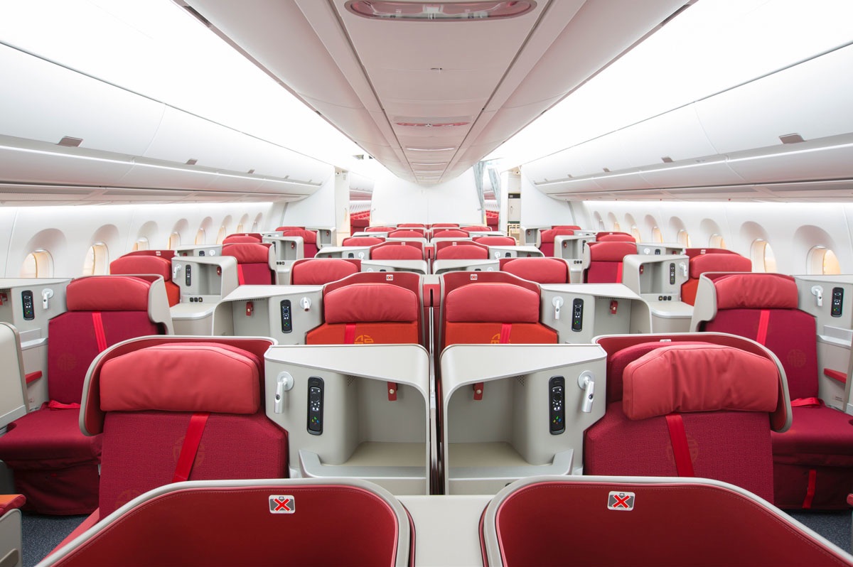 a row of red and white seats in an airplane