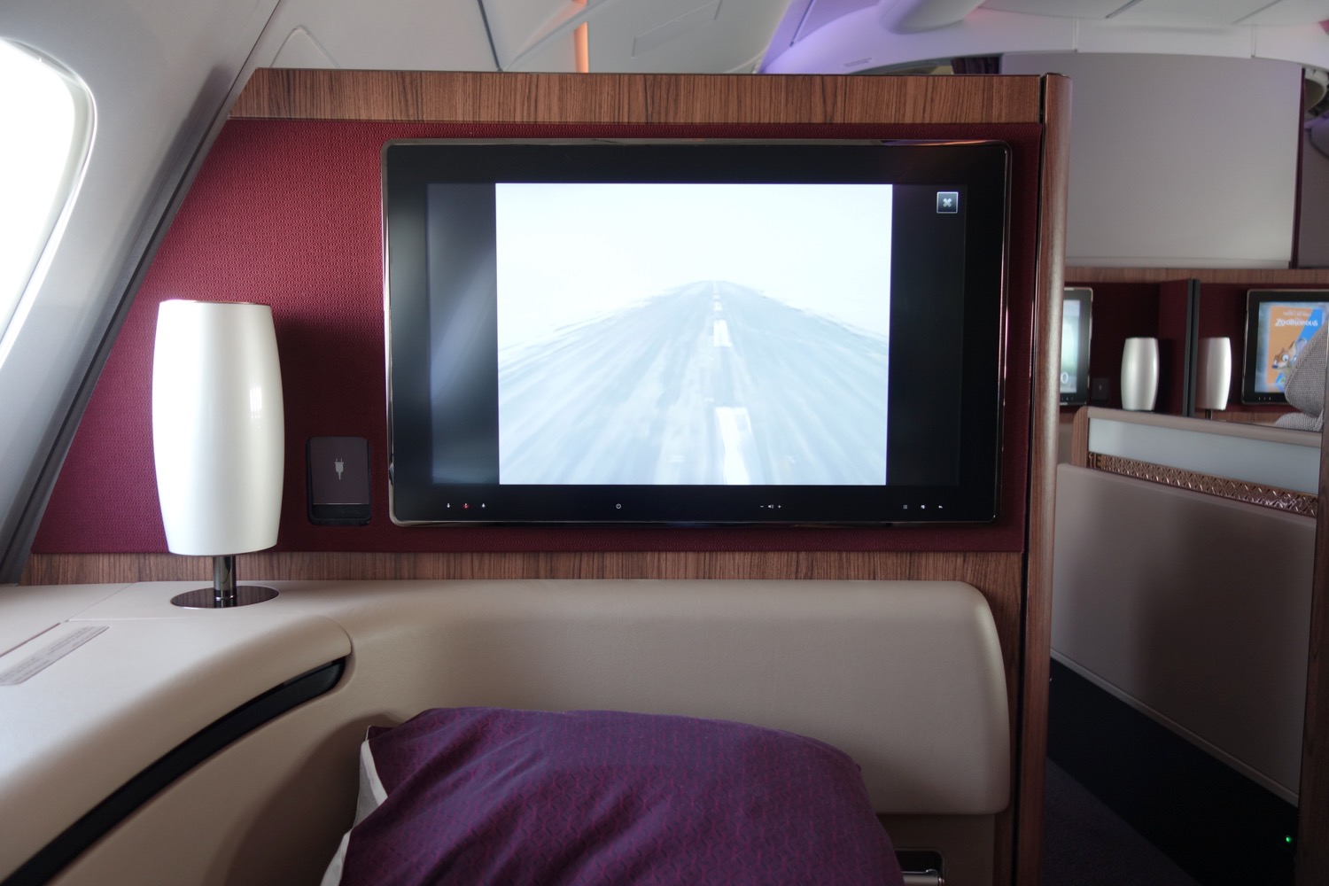 a television on the wall of an airplane