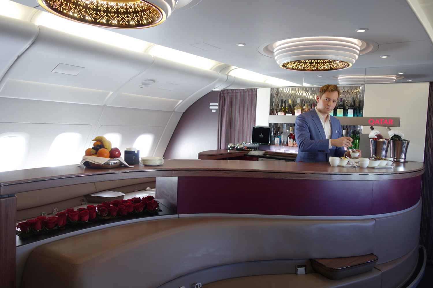 a man standing behind a counter in an airplane