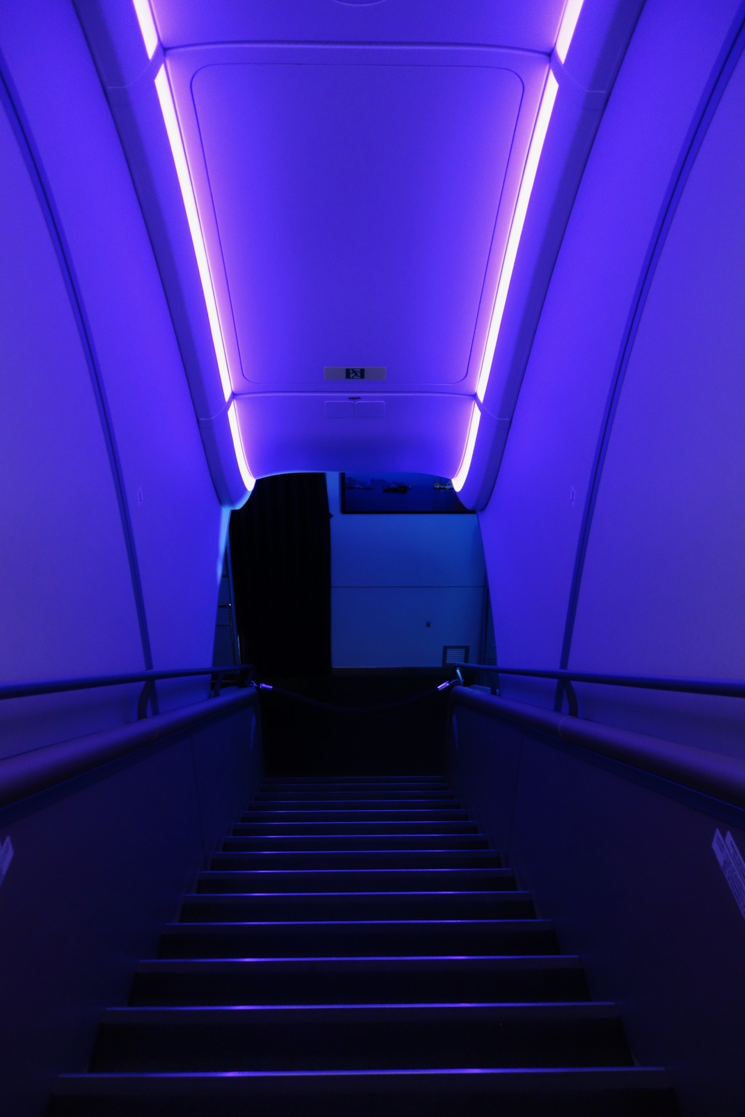 a stairway leading up to a blue light