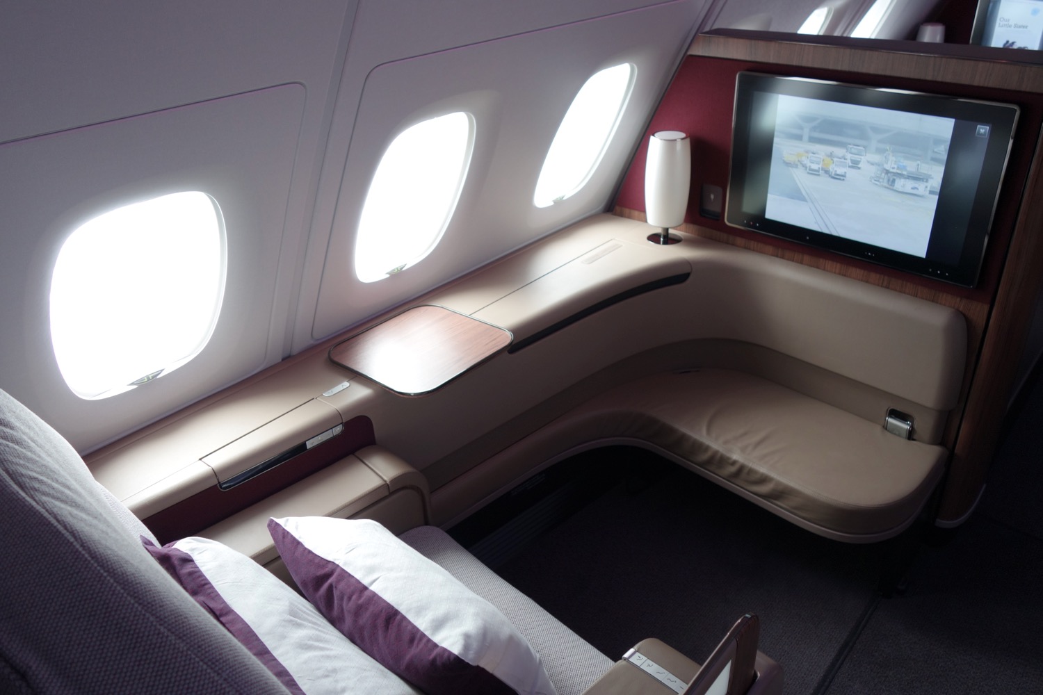 a bed and a tv in a plane
