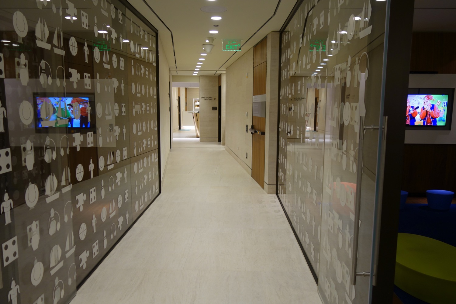 a hallway with glass walls and signs
