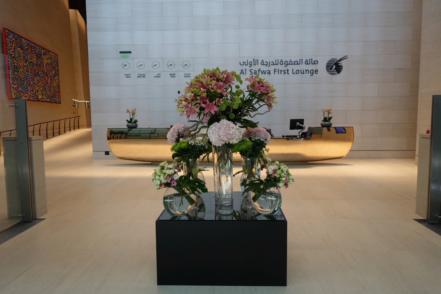 a vases of flowers on a table in a lobby