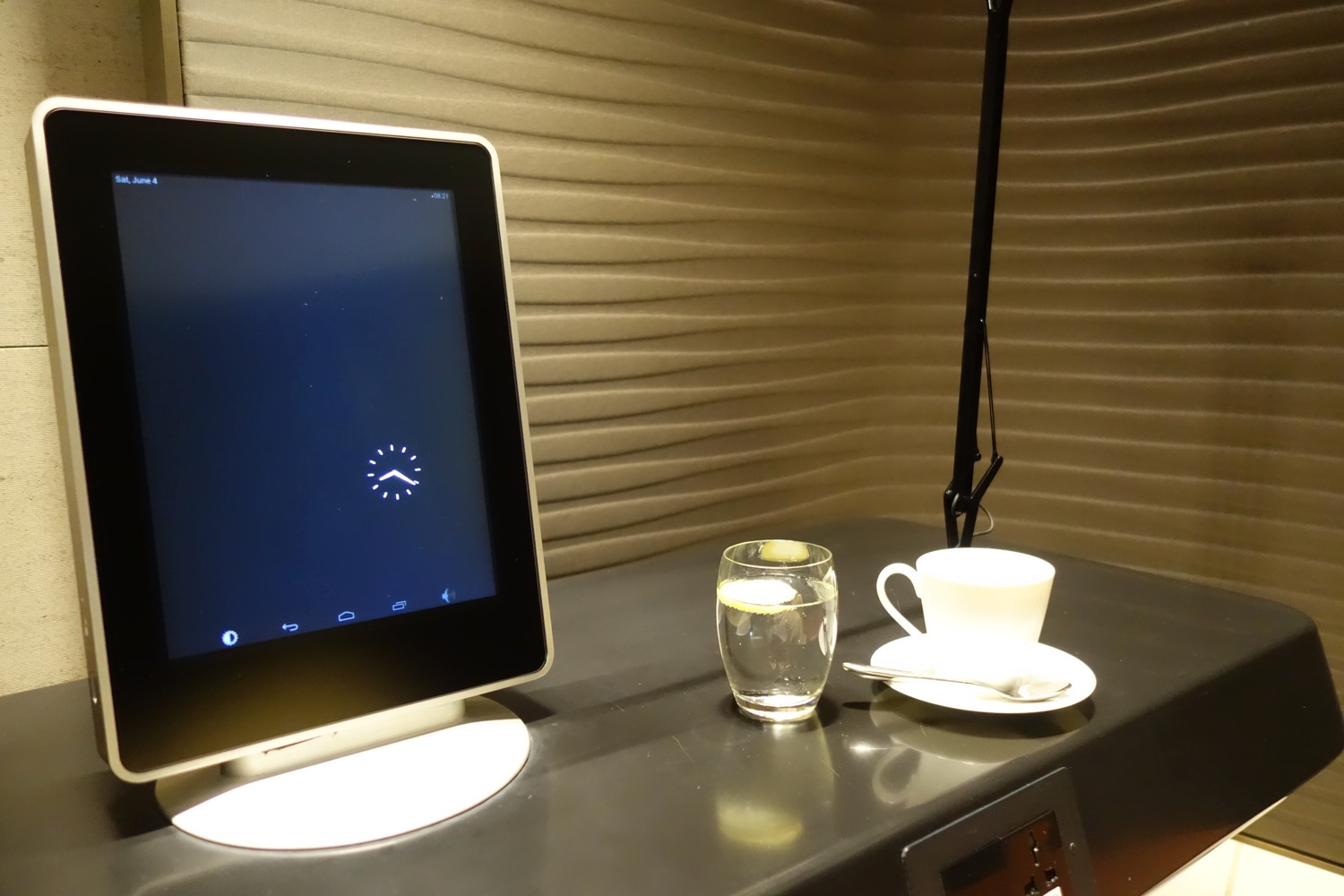 a computer screen and a cup of water on a table