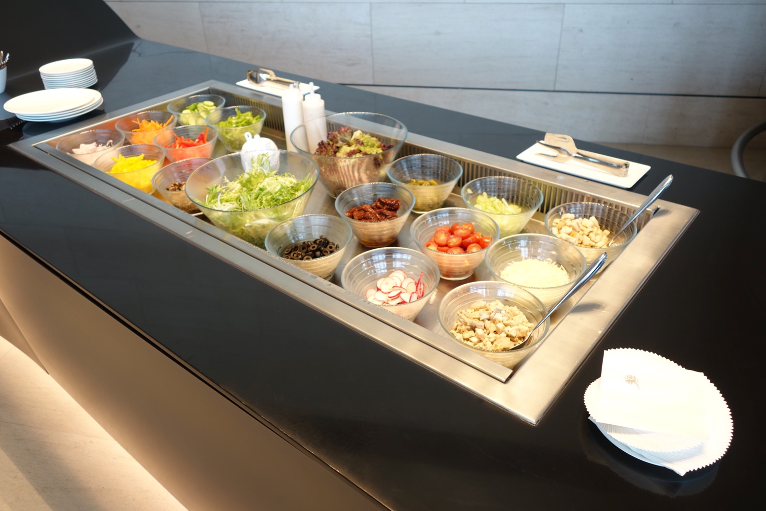 a salad bar with bowls of food