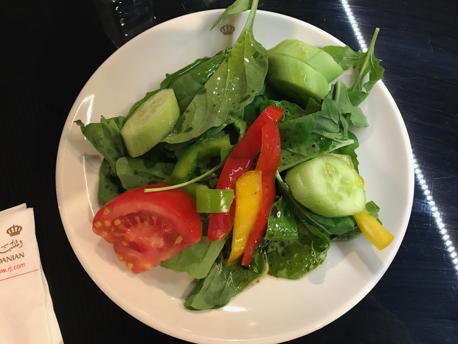 a plate of salad with vegetables on it