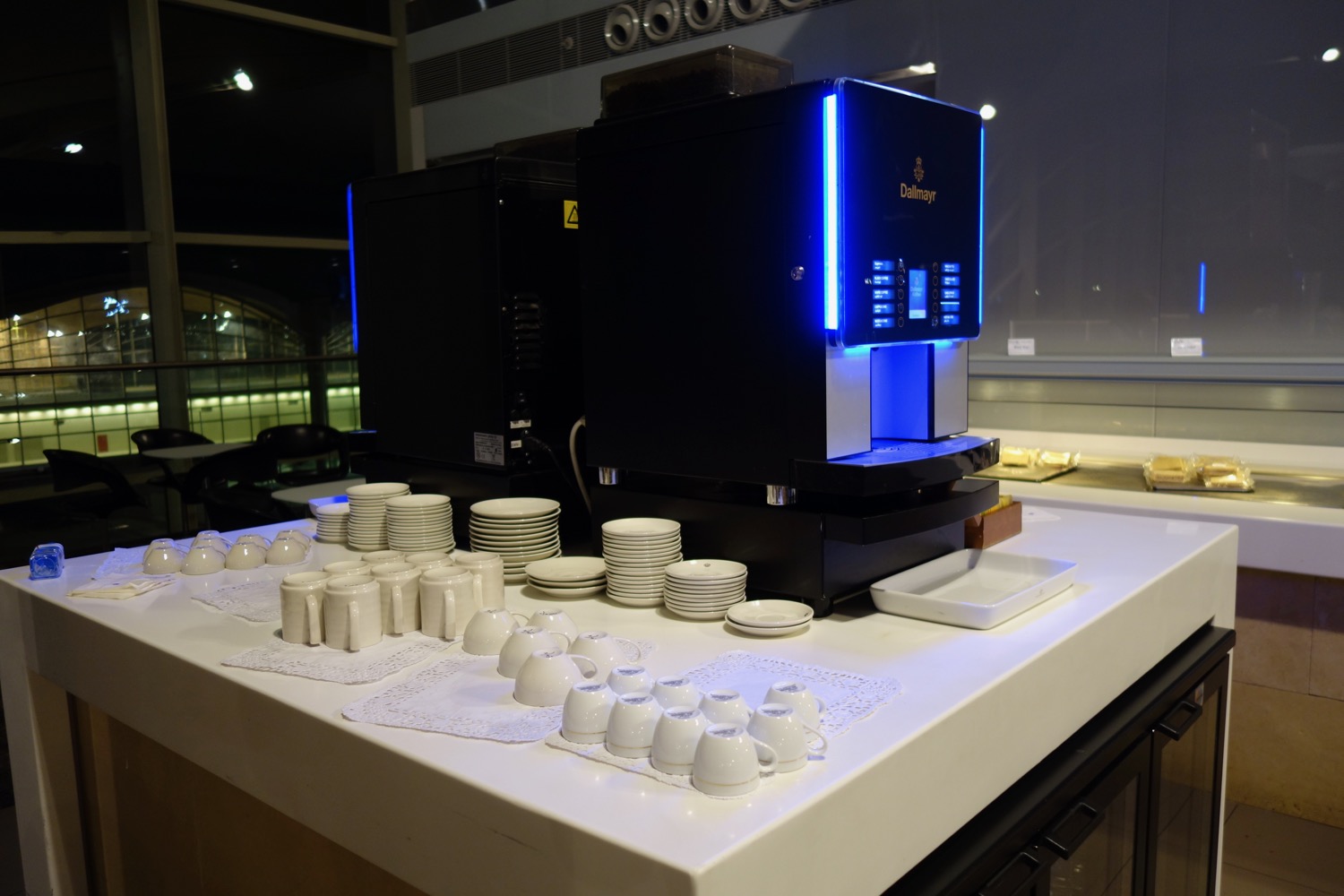 a machine with cups and plates on a table