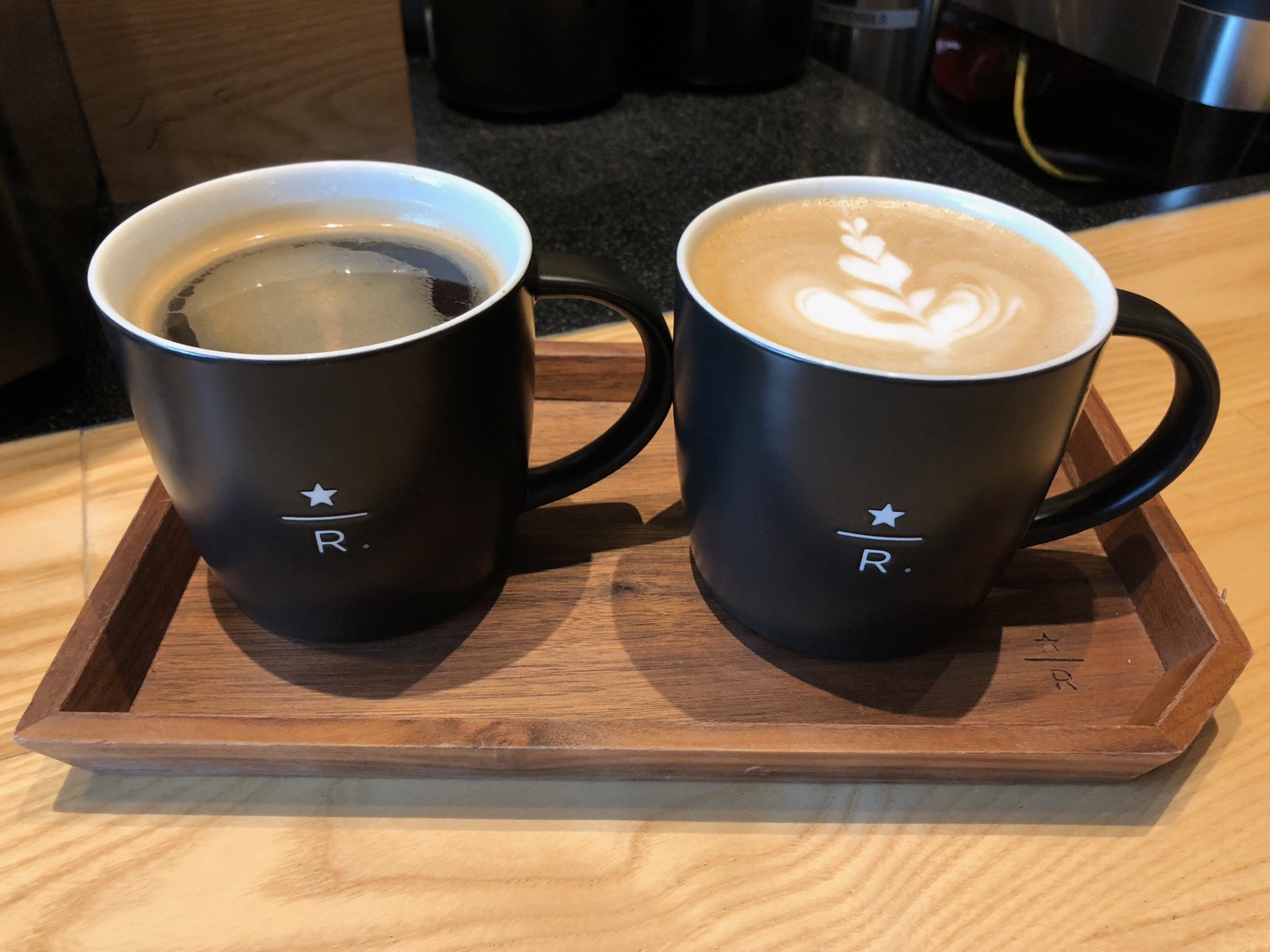 two cups of coffee on a tray