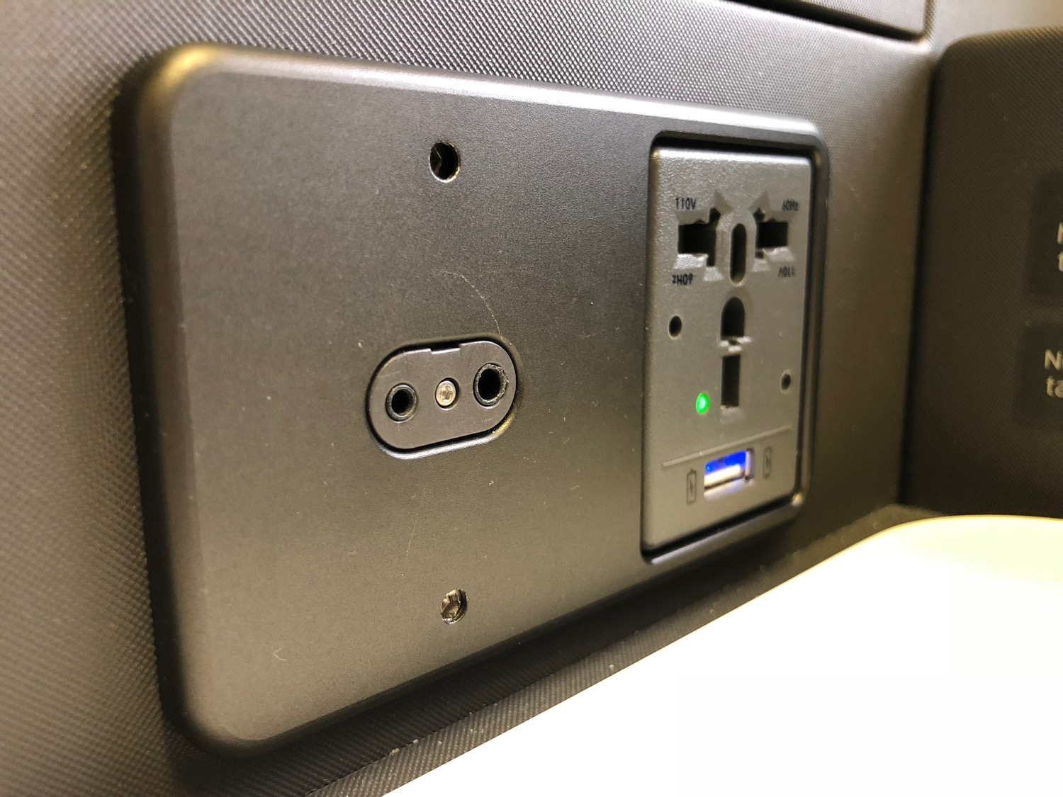 a black wall outlet with a plug and a usb port