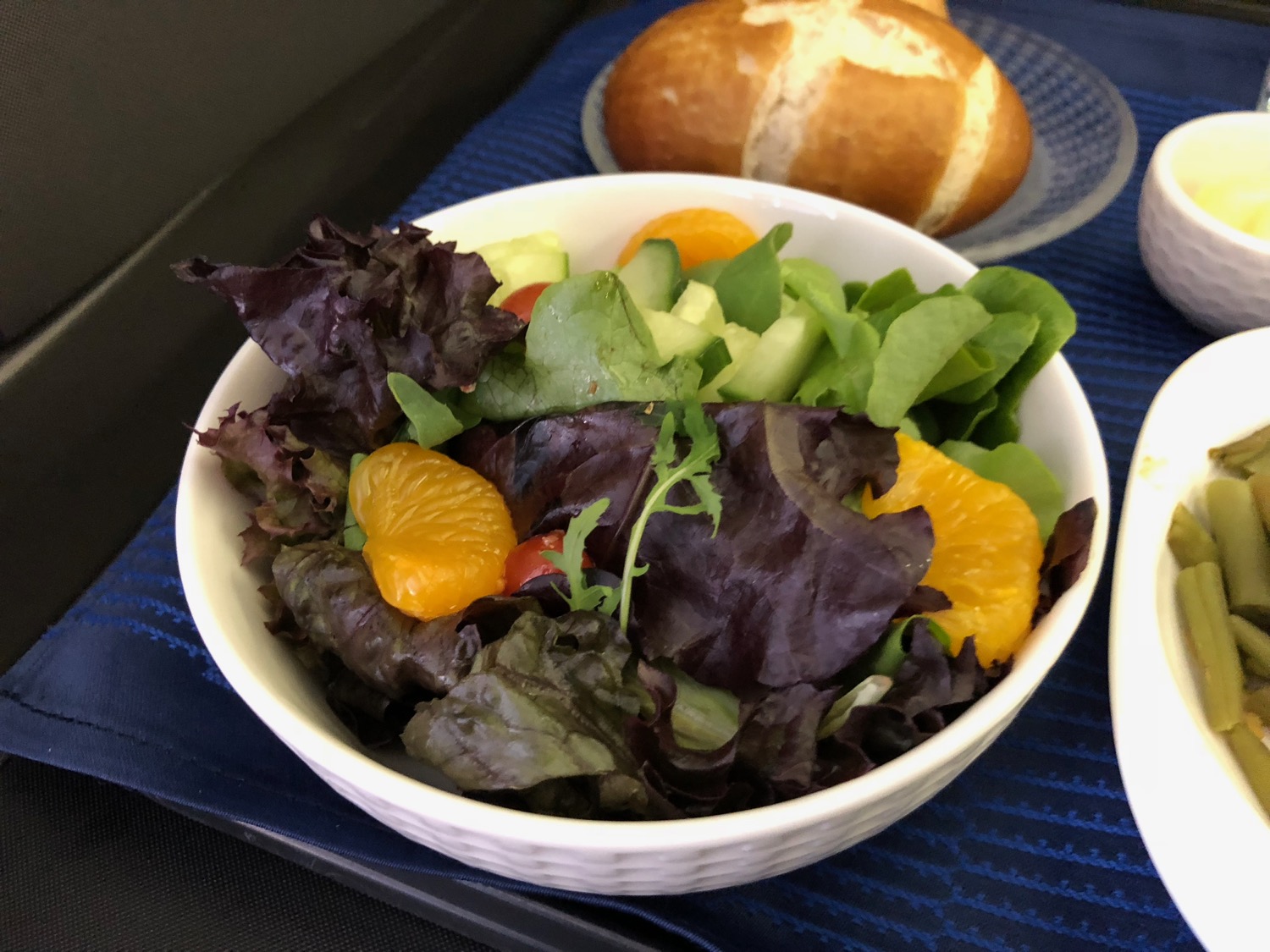 a bowl of salad with oranges and lettuce