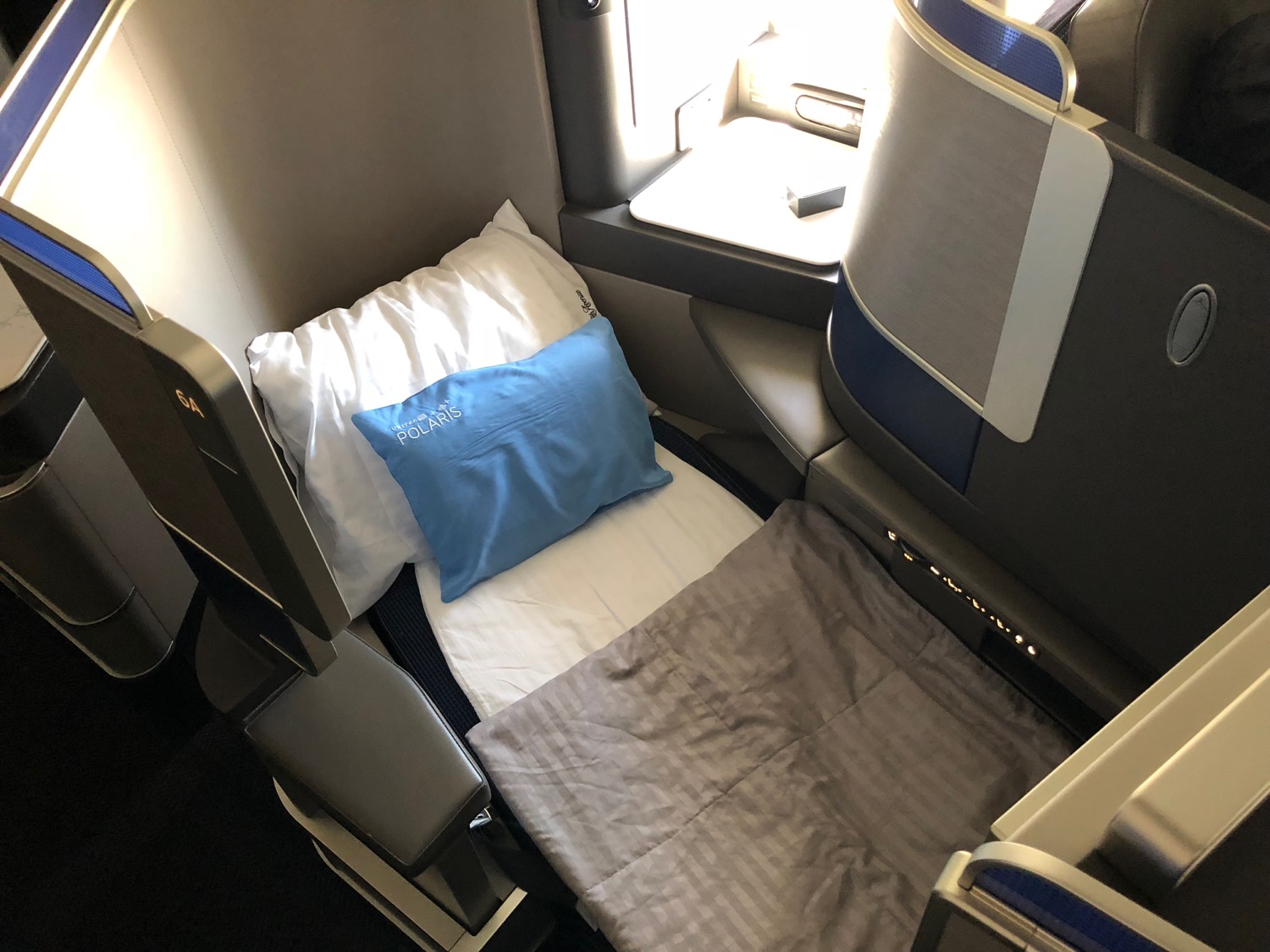 a bed and pillow in an airplane