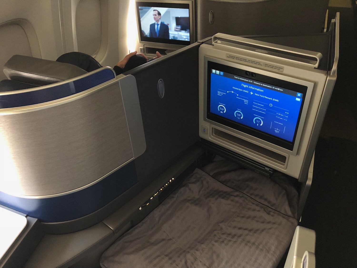 a tv and a bed in an airplane