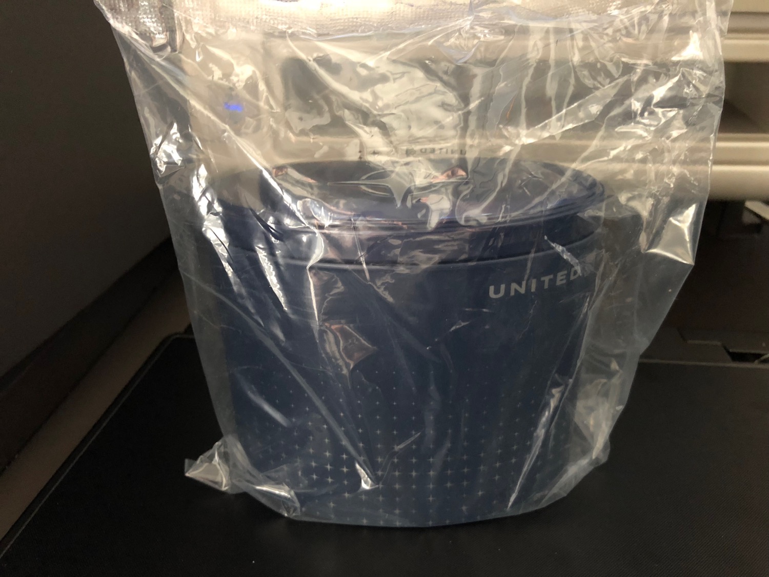 a plastic bag with a blue container inside