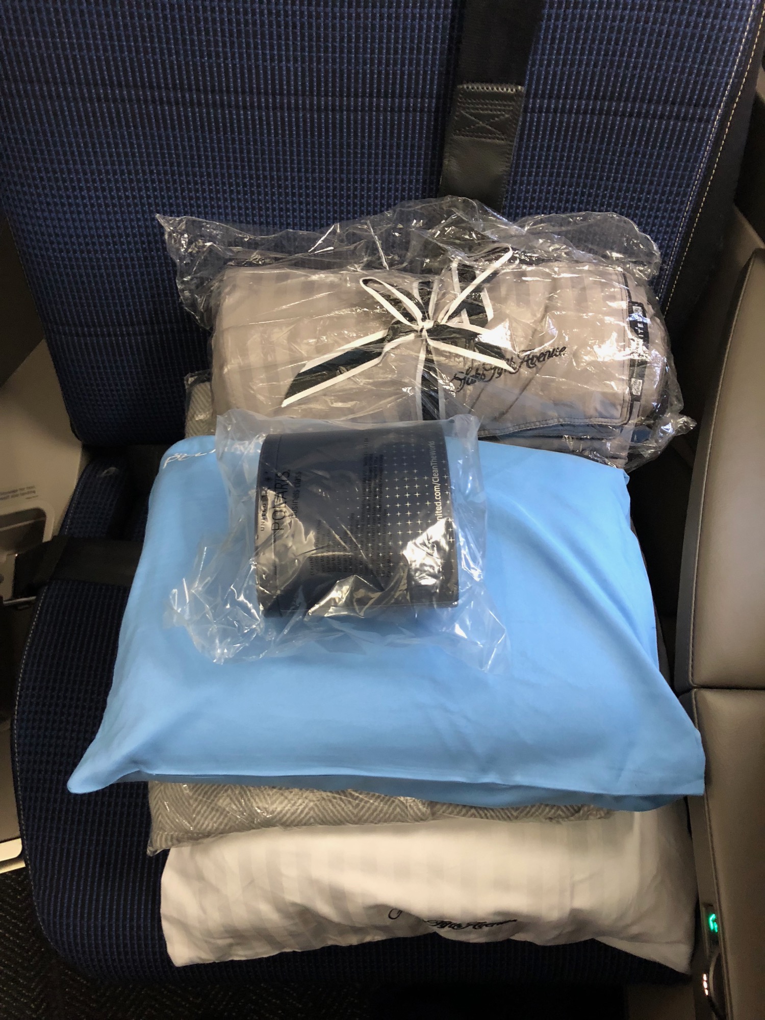 a group of pillows and blankets in a plastic bag