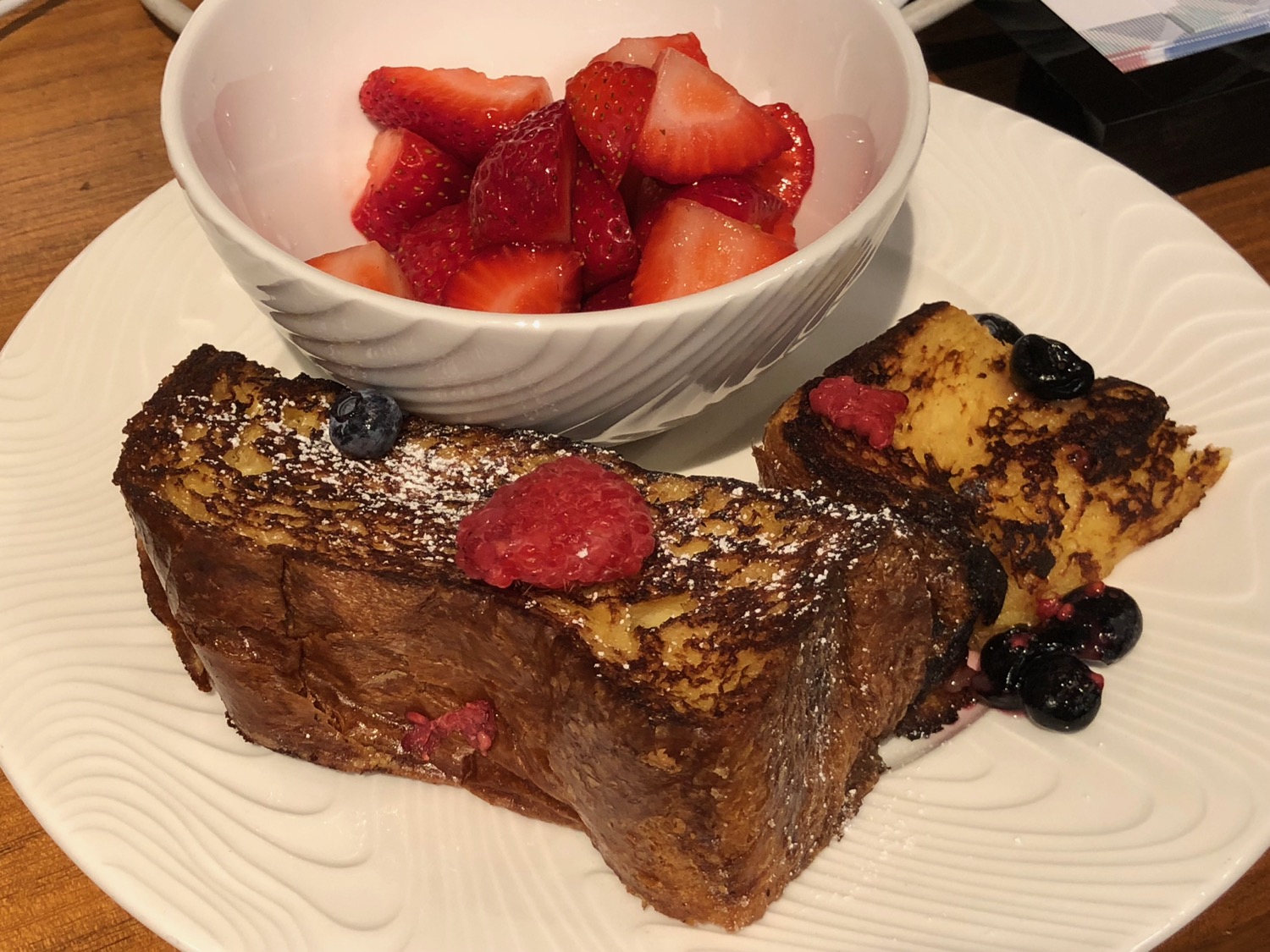 a plate of french toast and fruit