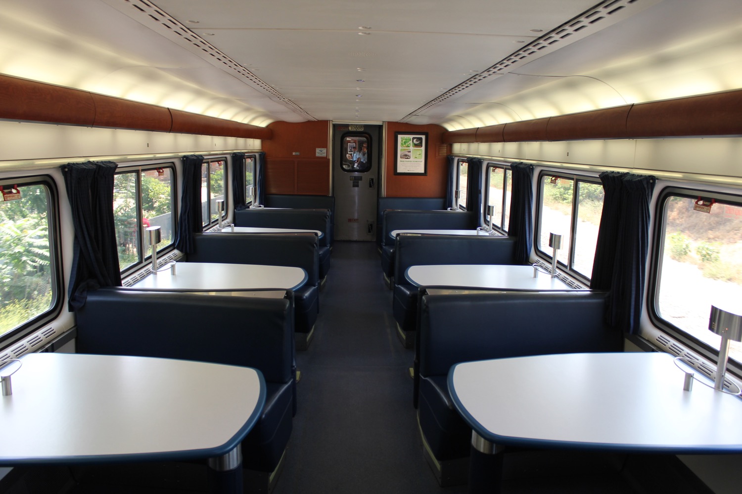 inside a train with tables and seats
