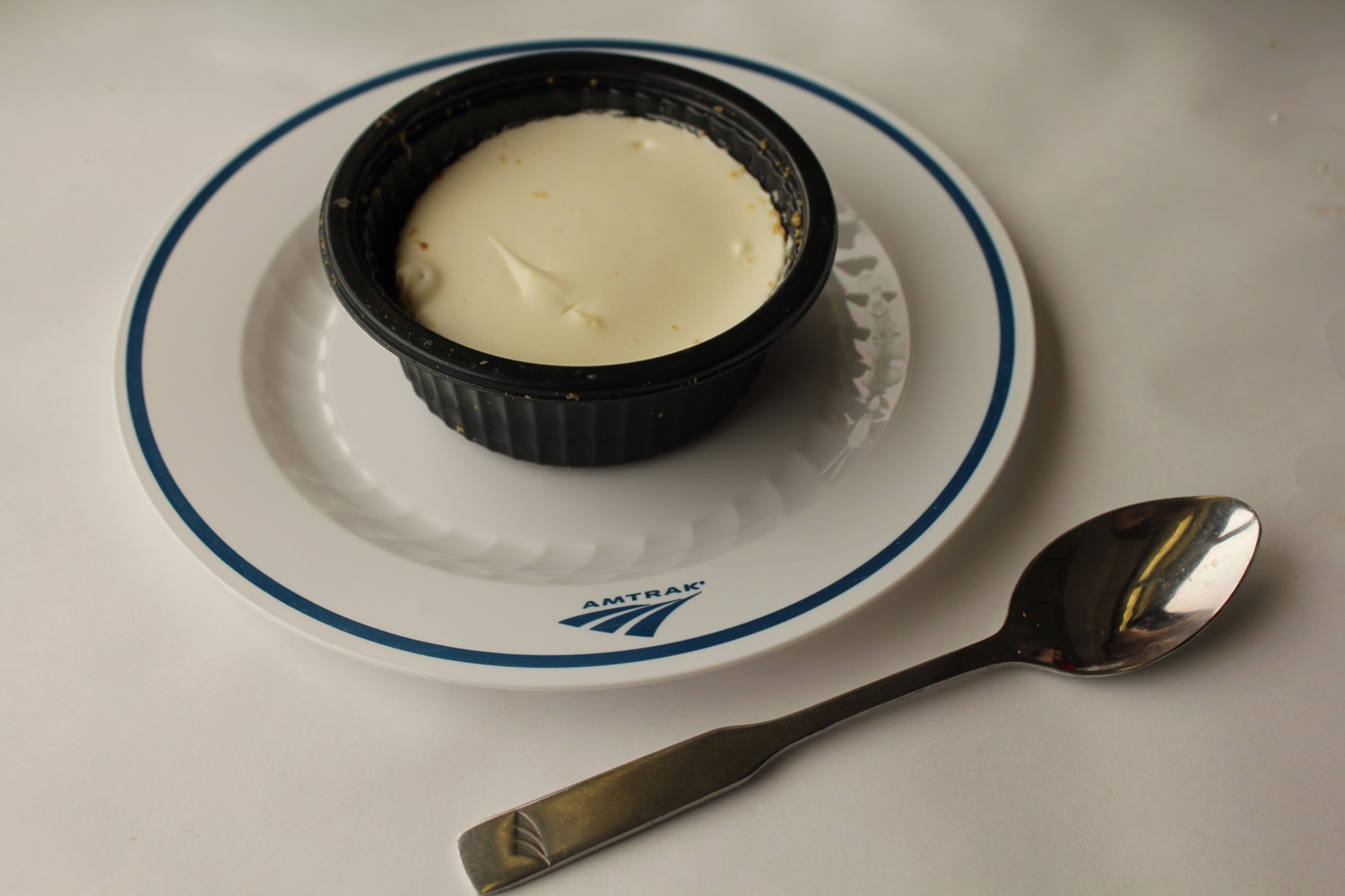 a plate with a white food on it and a spoon