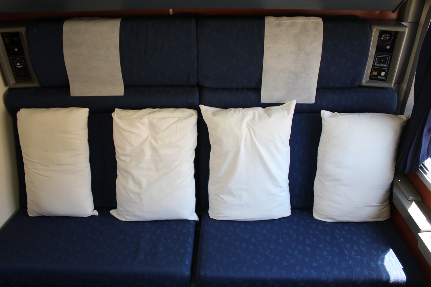 a blue and white couch with white pillows