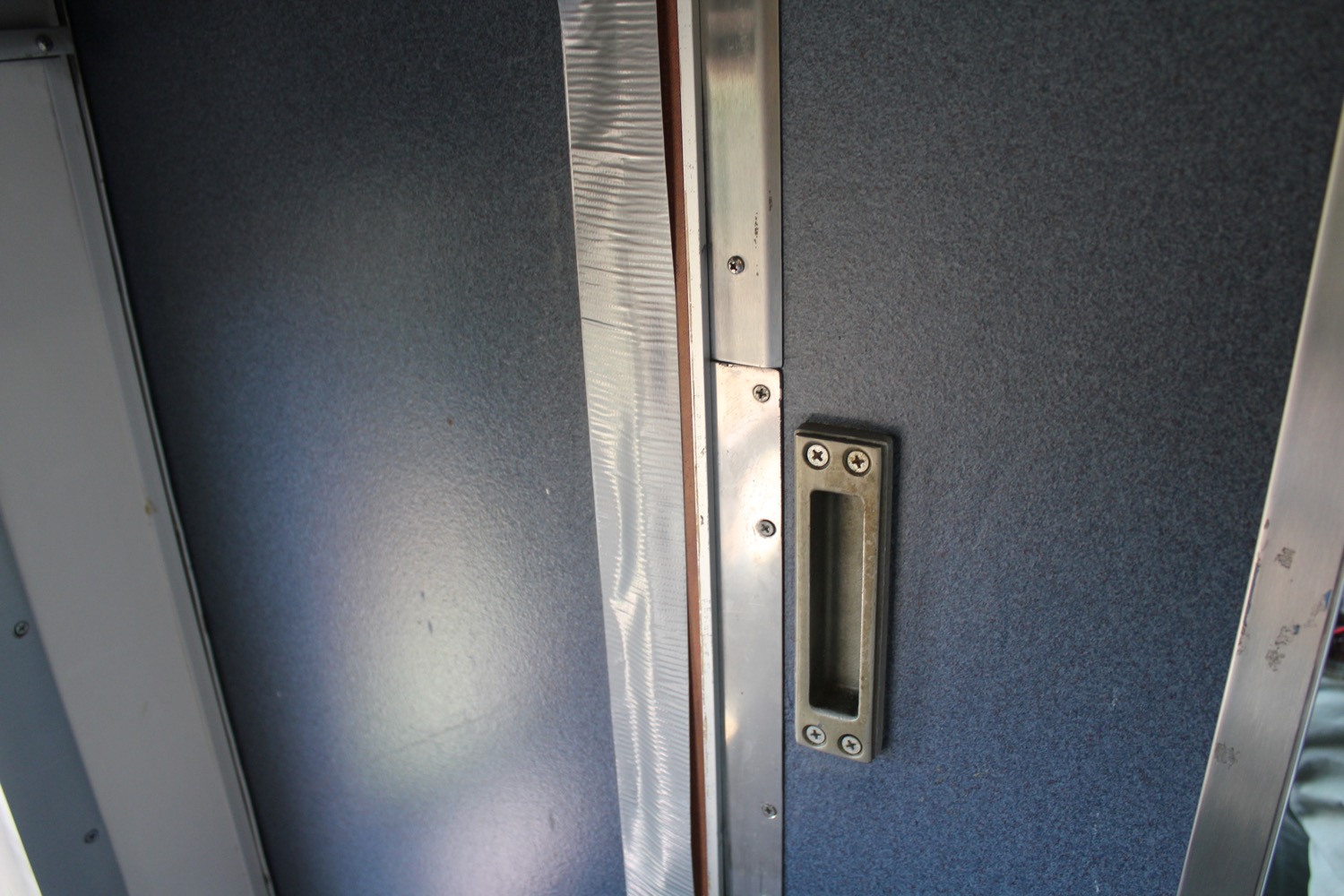a metal door handle and a rectangular door handle